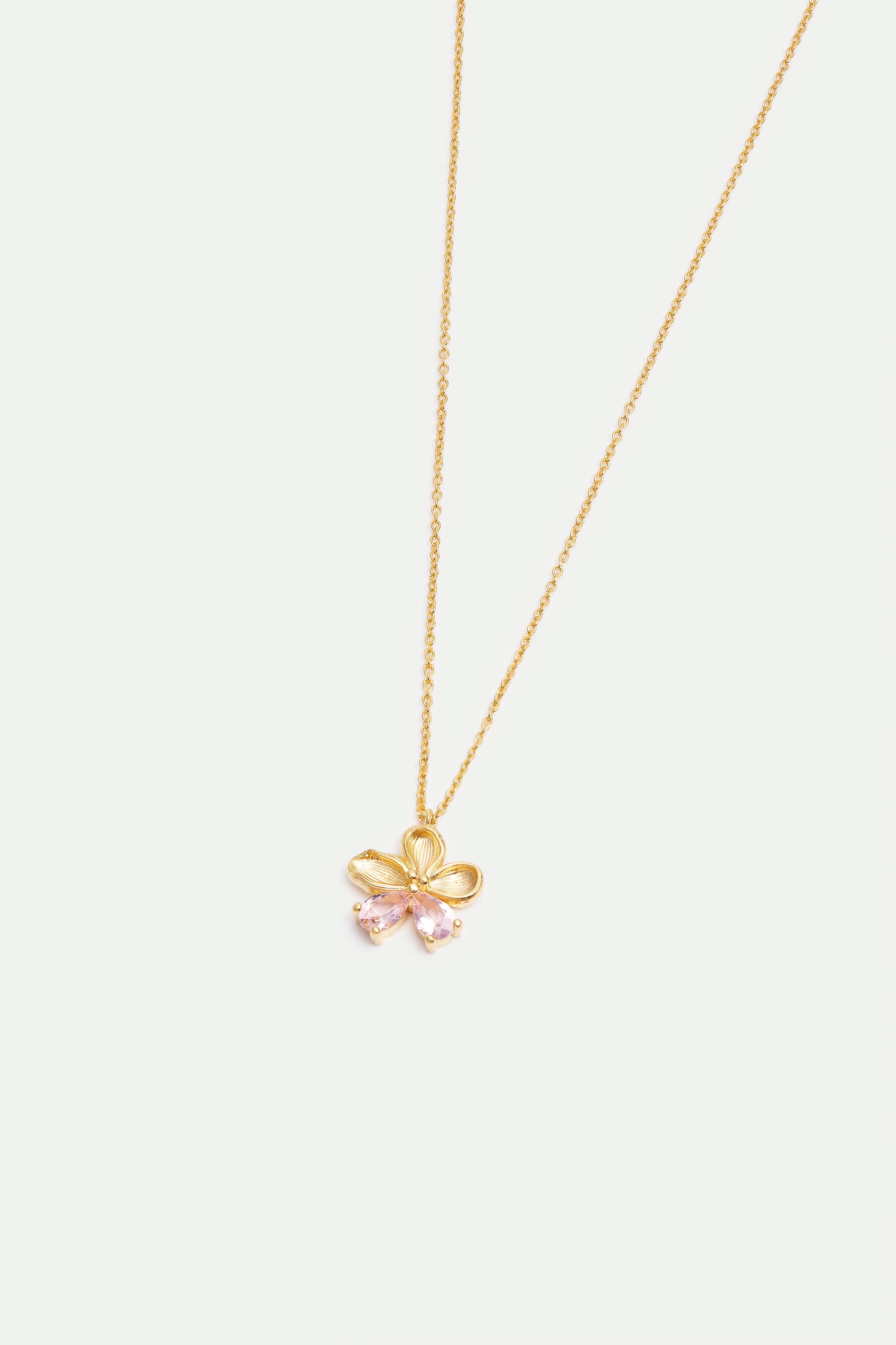 Gold-toned necklace with a flower pendant featuring textured petals, a small center bead, and two light pink teardrop stones.