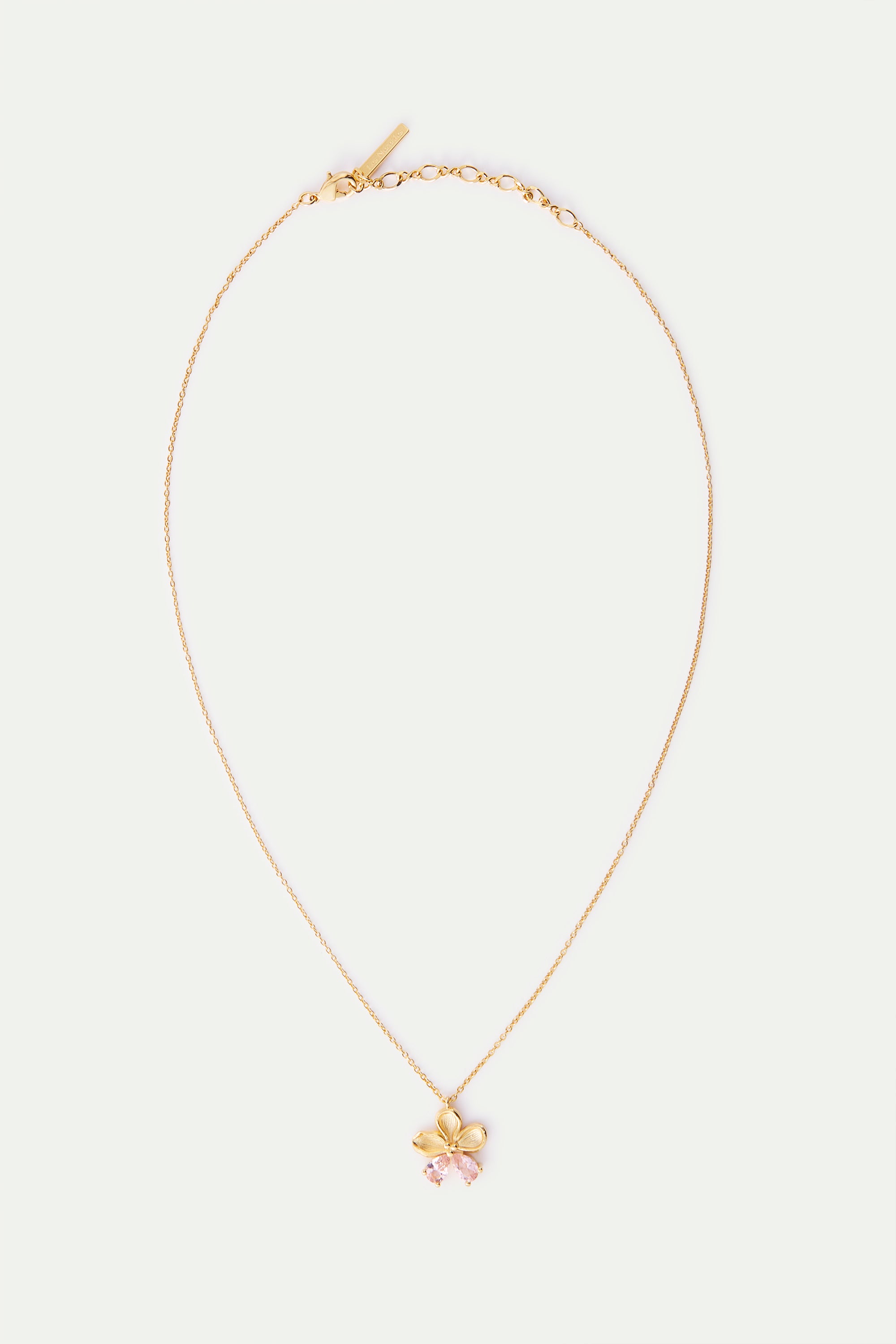 Gold-toned delicate chain necklace with a five-petal flower pendant and two pink faceted tear-drop stones.