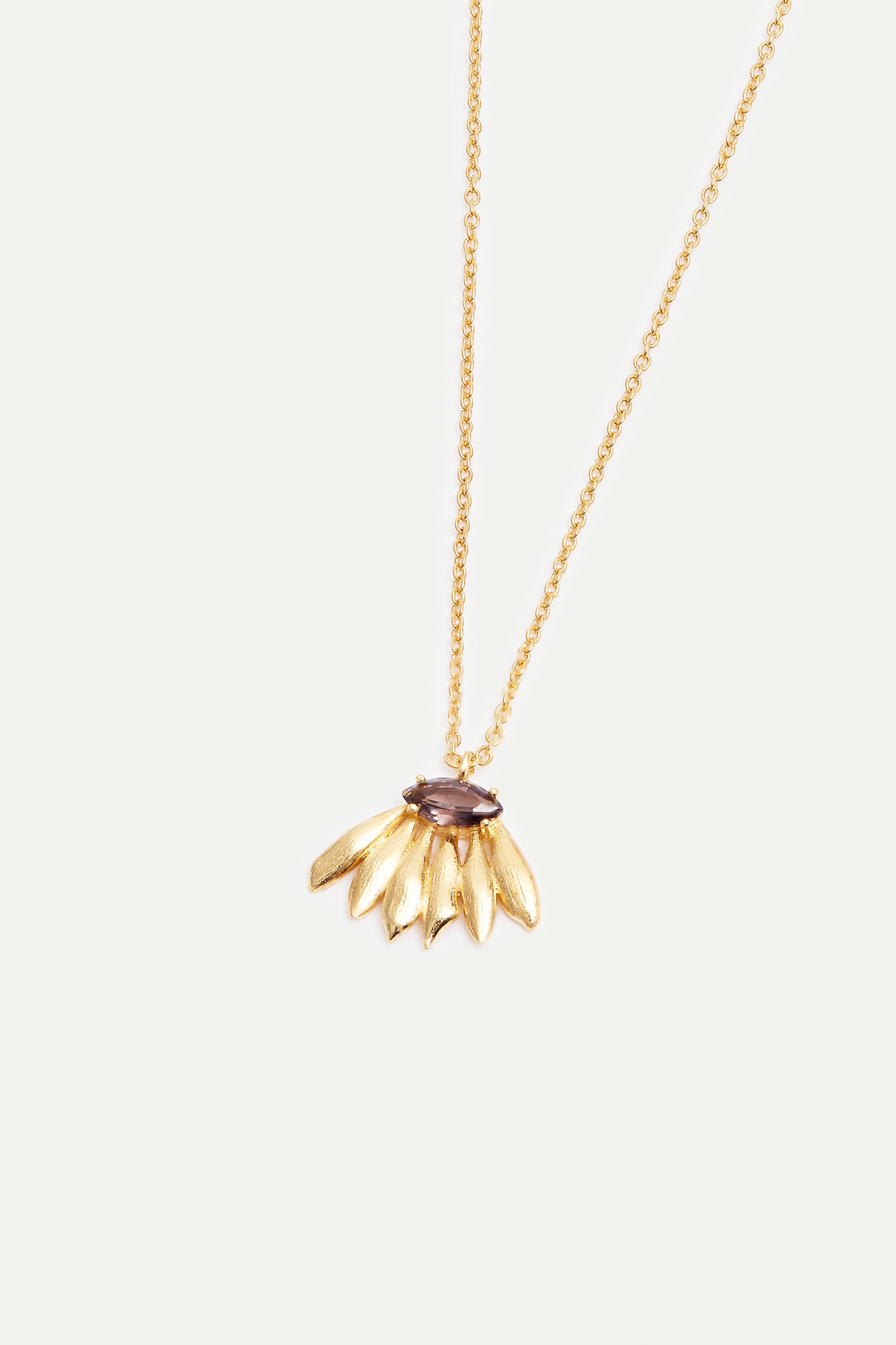 Gold-toned necklace with a dark purple marquise gemstone above a fan of six textured gold-toned leaf-shaped elements.