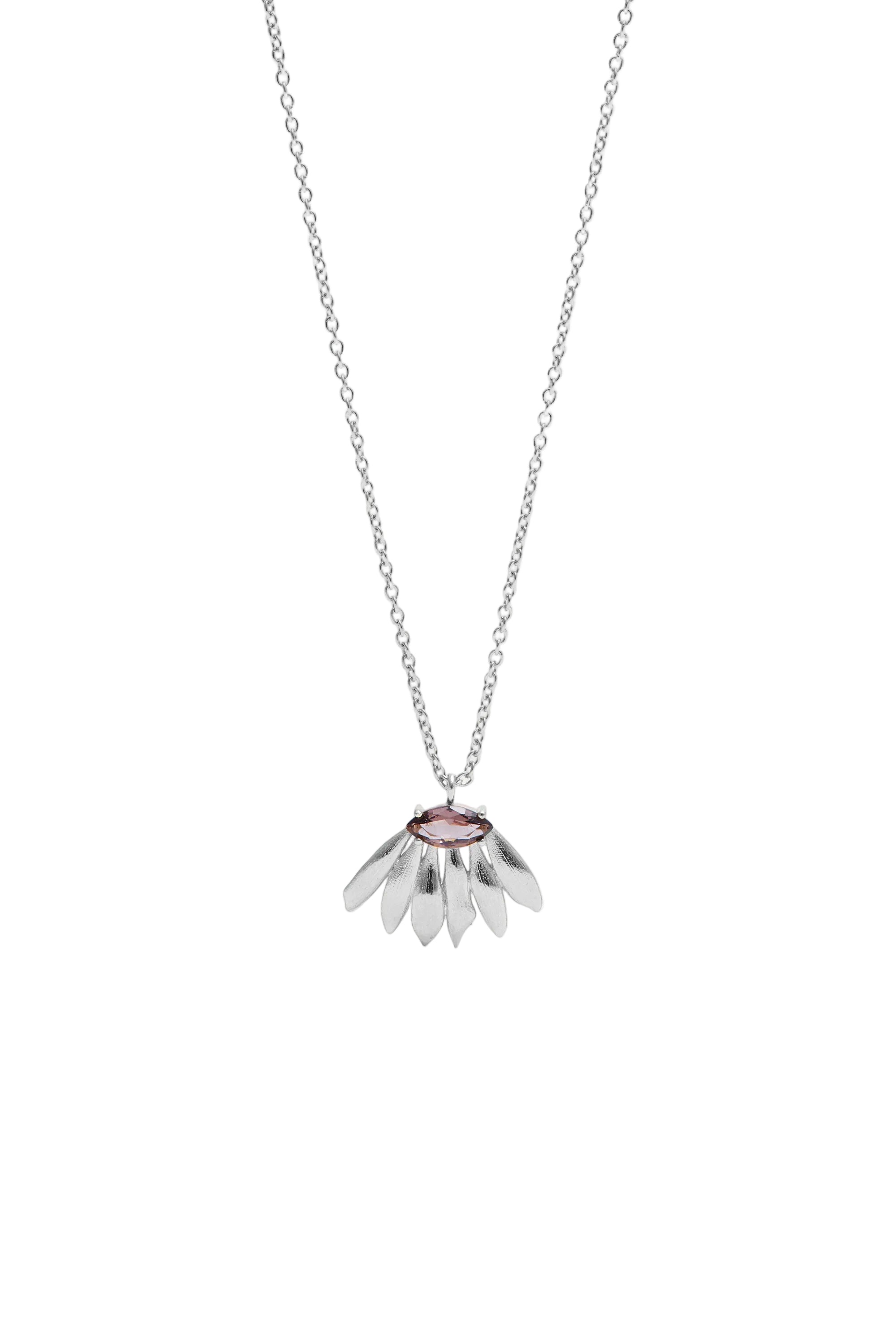 Silver-toned necklace with a delicate chain and a pendant featuring brushed metal petals and a central pink oval stone.
