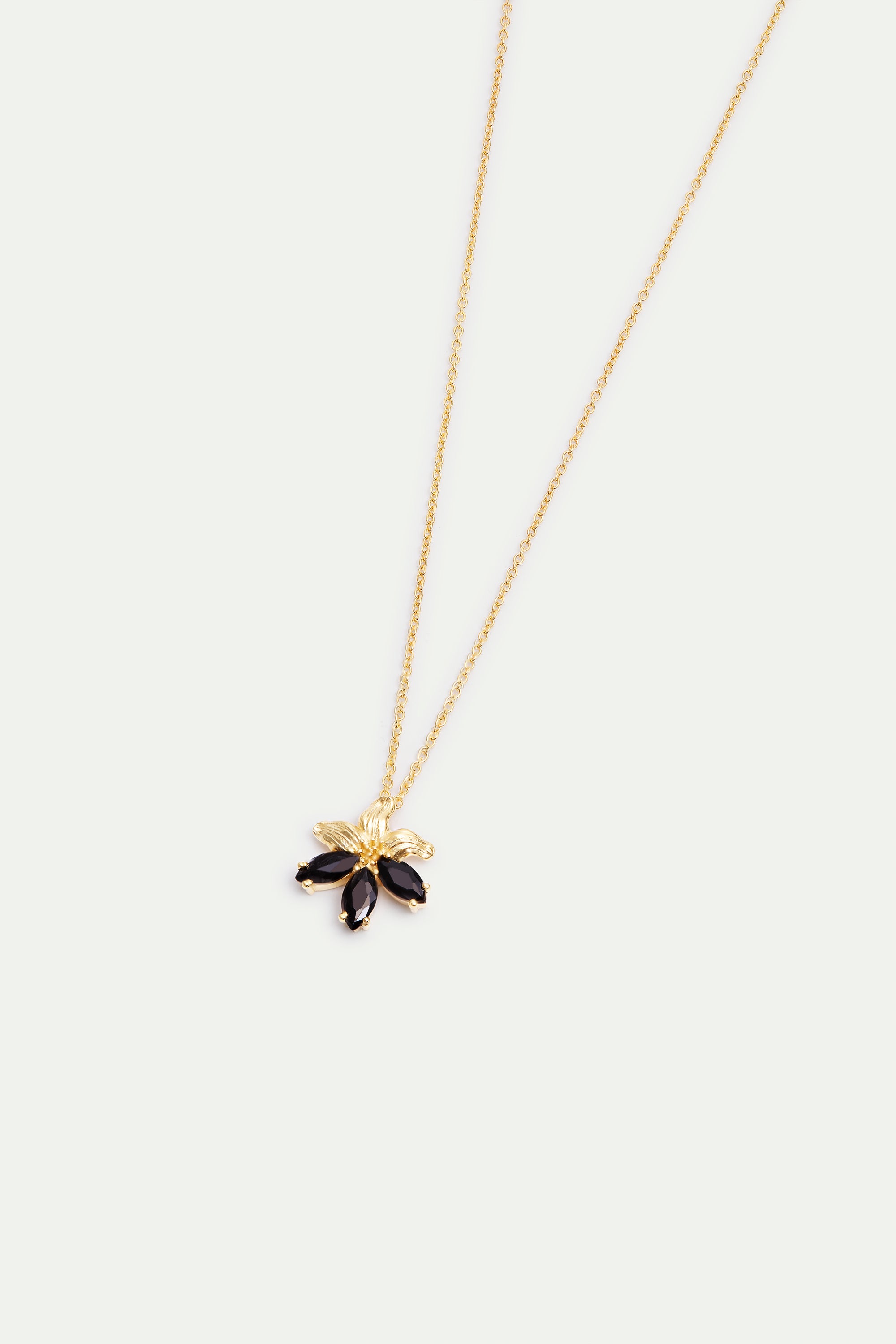 Gold-toned necklace with a flower pendant featuring textured gold-toned petals and five marquise-cut black stones.
