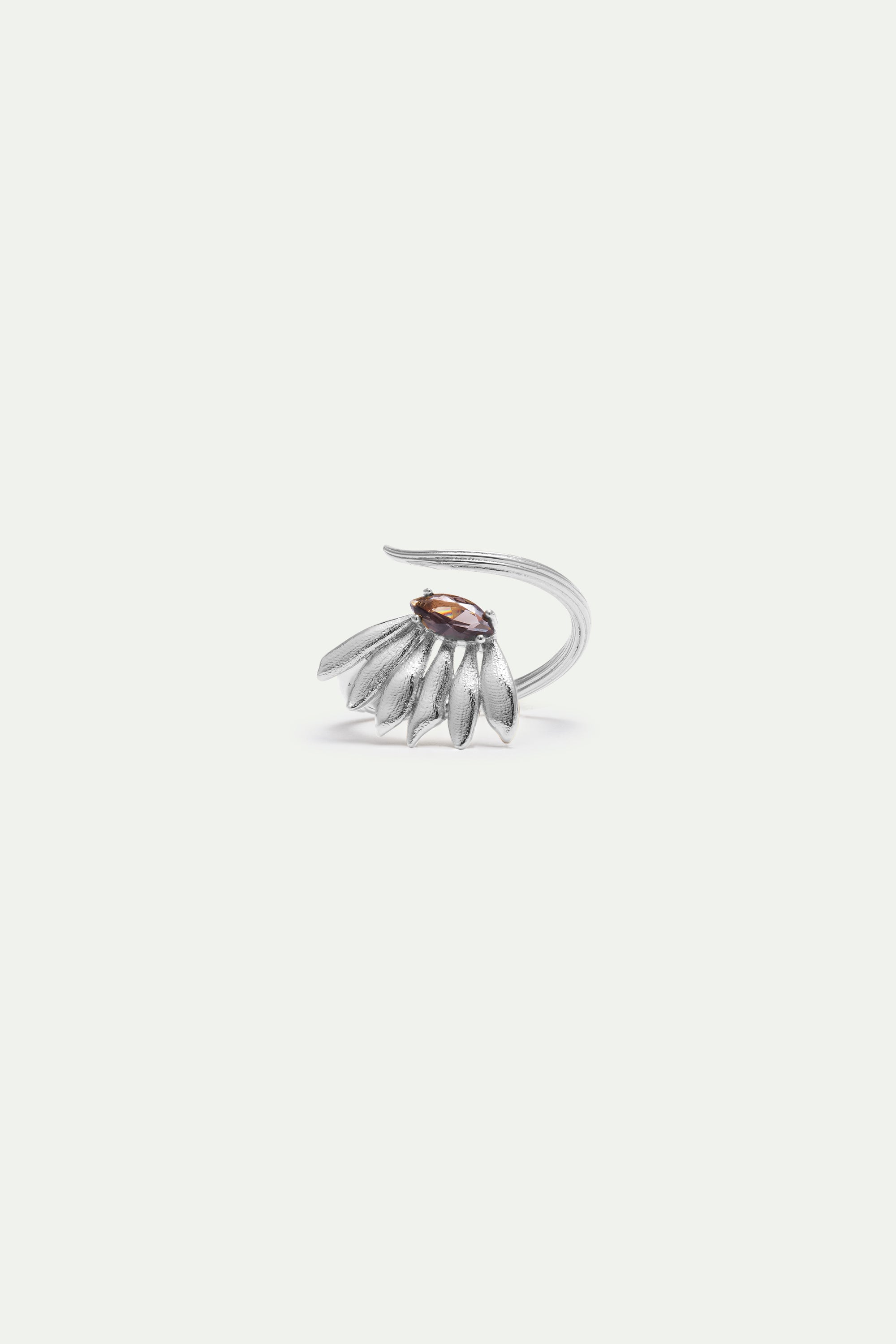 Silver-toned adjustable ring with a textured band, featuring a cluster of leaf-like shapes and an oval brown-purple stone.