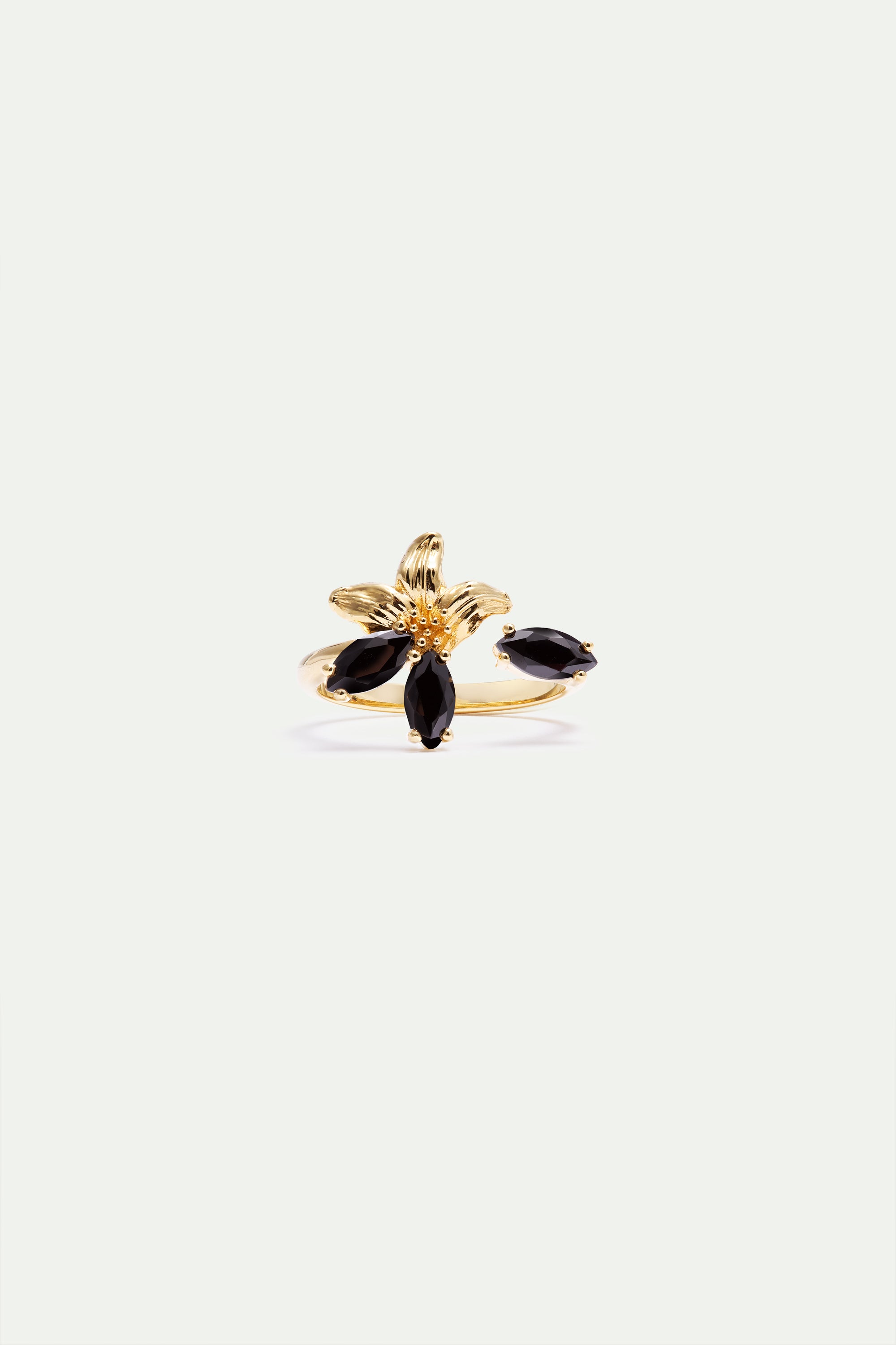 Gold-toned adjustable ring with a textured flower design, featuring three black marquise-cut stones and one separate black ma