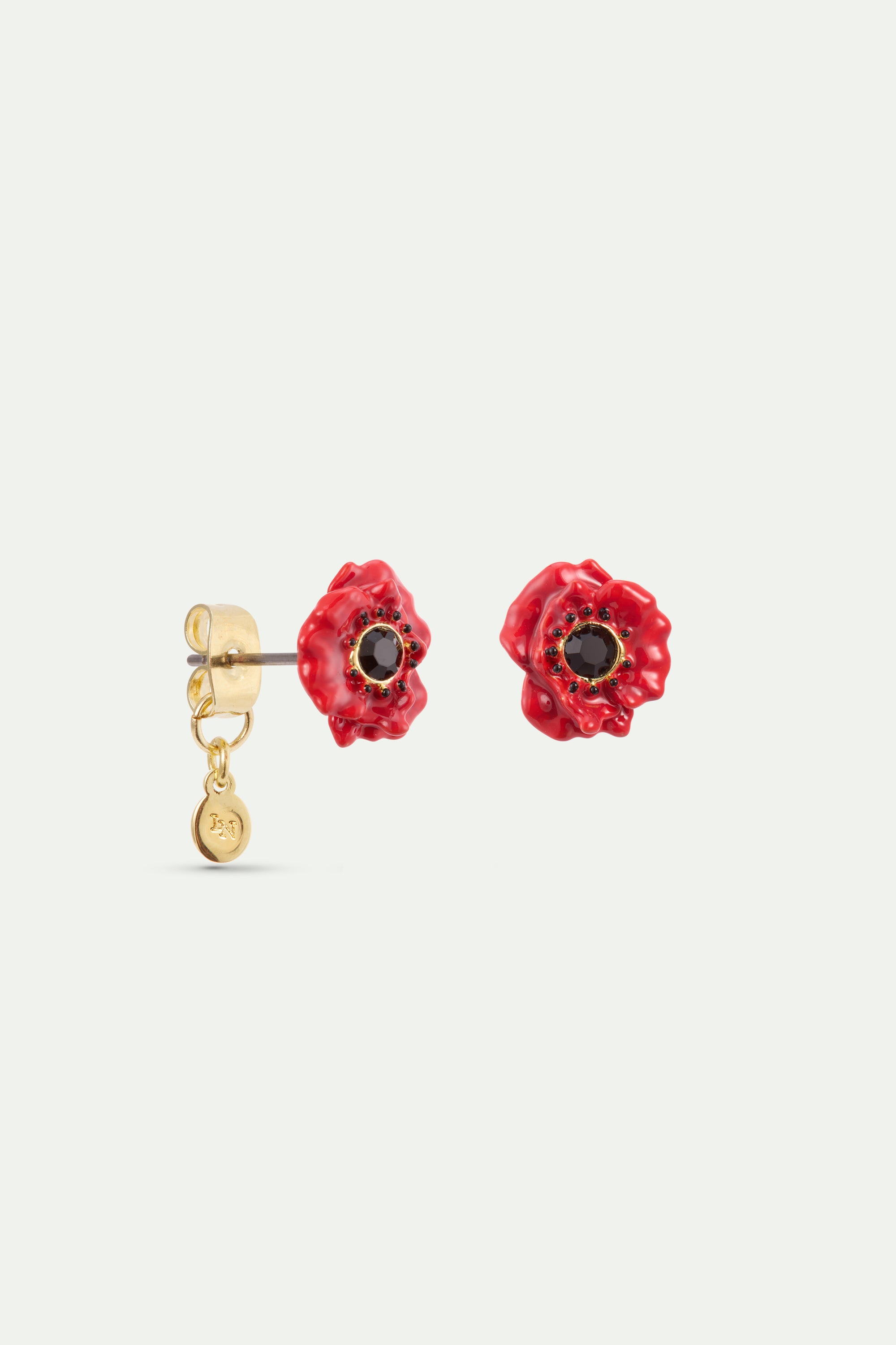Two red poppy earrings, each with a black stone center. Left earring has a gold-toned post, back, and charm. Right earring is