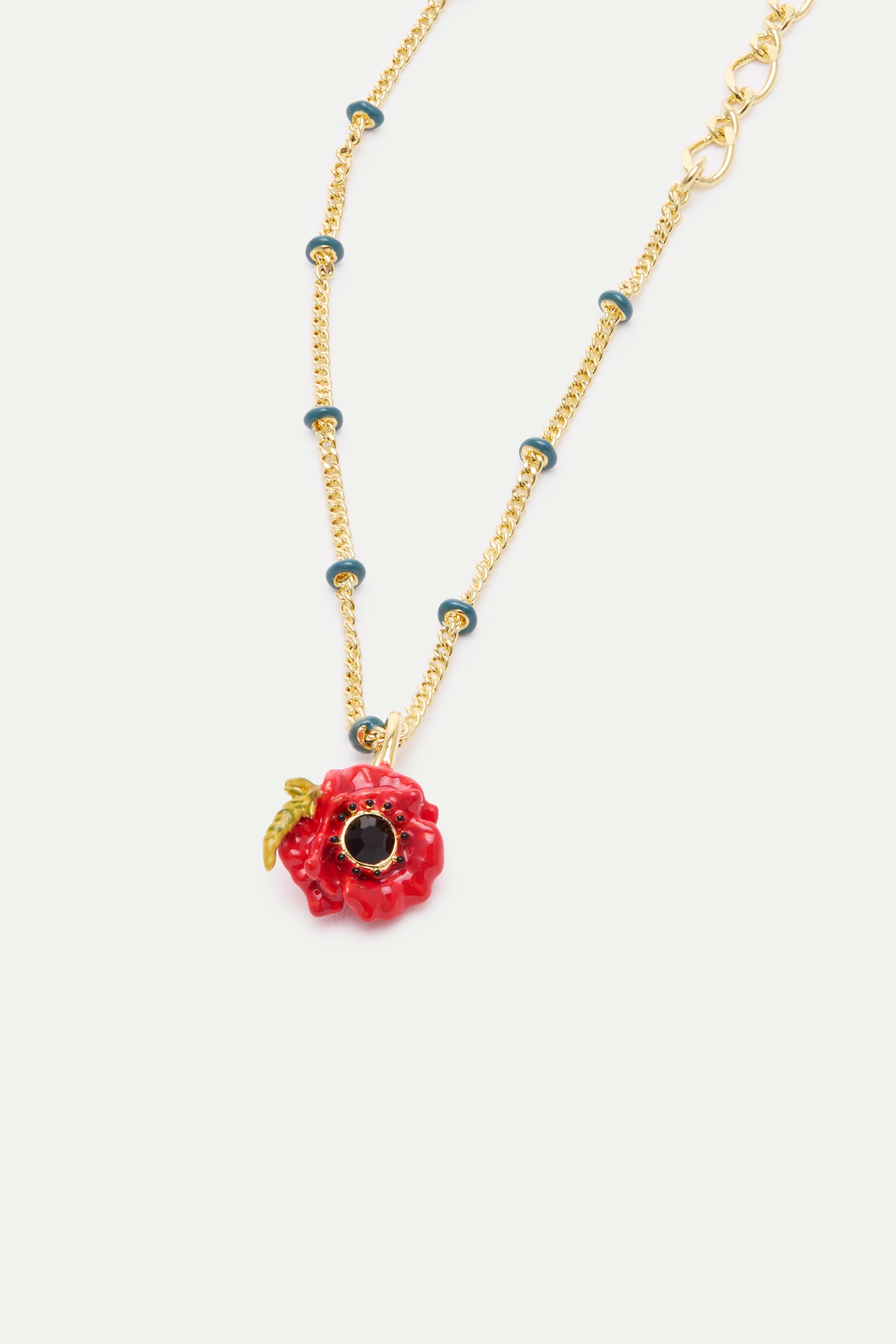 Gold-toned chain necklace with teal enamel rings and a red poppy pendant featuring a black center and green leaf.