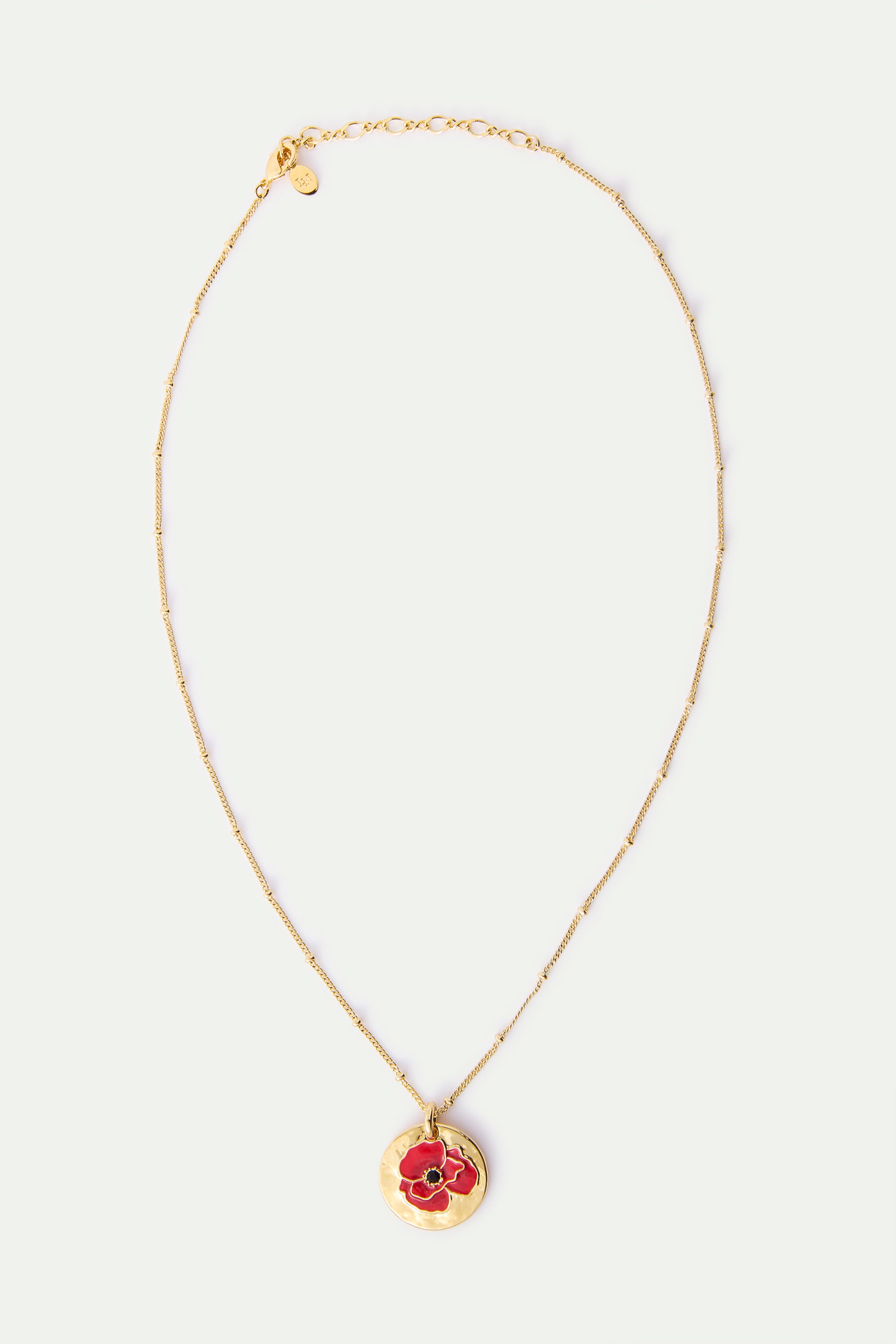 Gold-toned beaded chain necklace with a round, hammered gold-toned pendant featuring a red poppy flower with a black center.