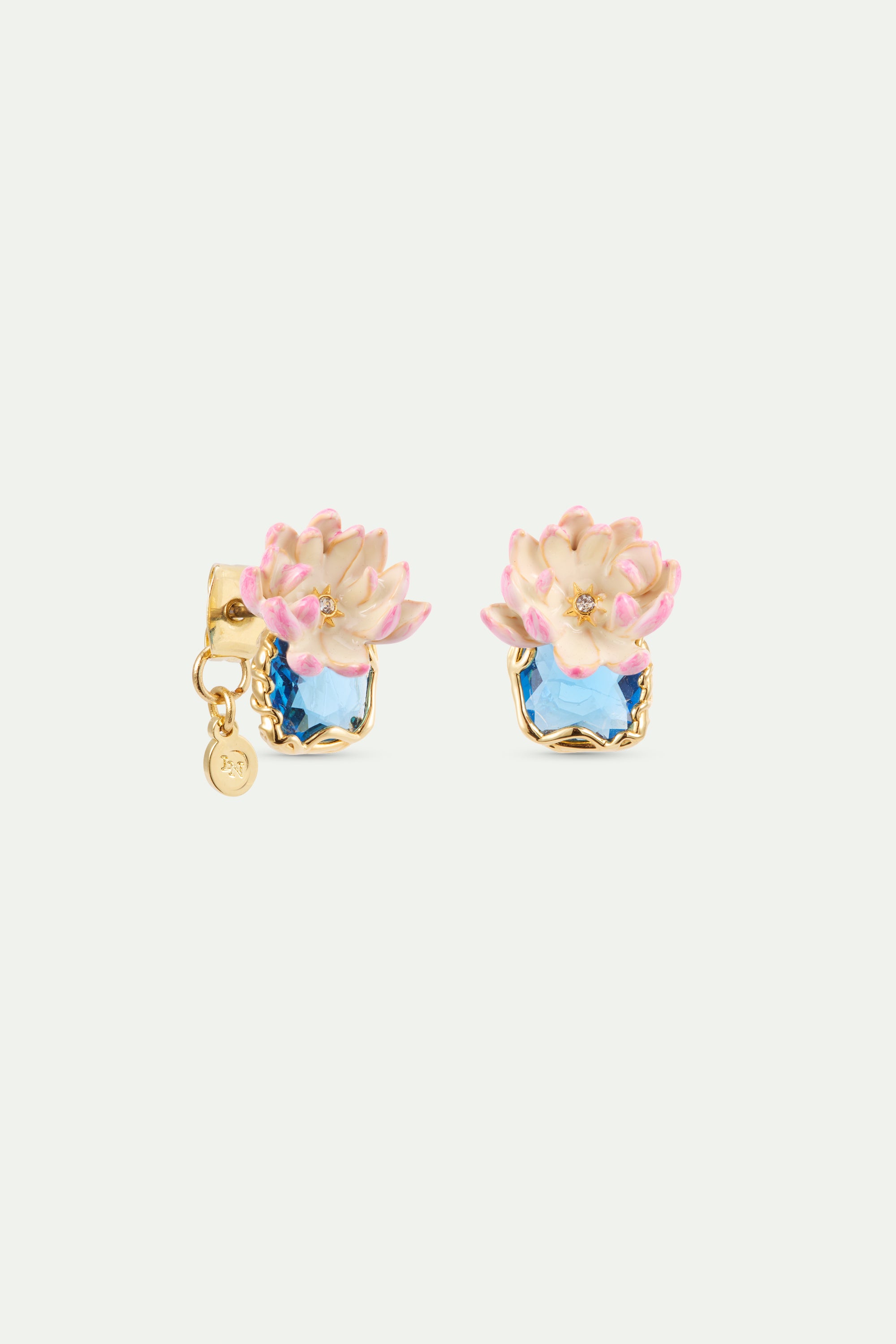 Gold-toned post earrings with light blue stones and cream/pink flowers, each with a crystal. Left earring has a disc charm.