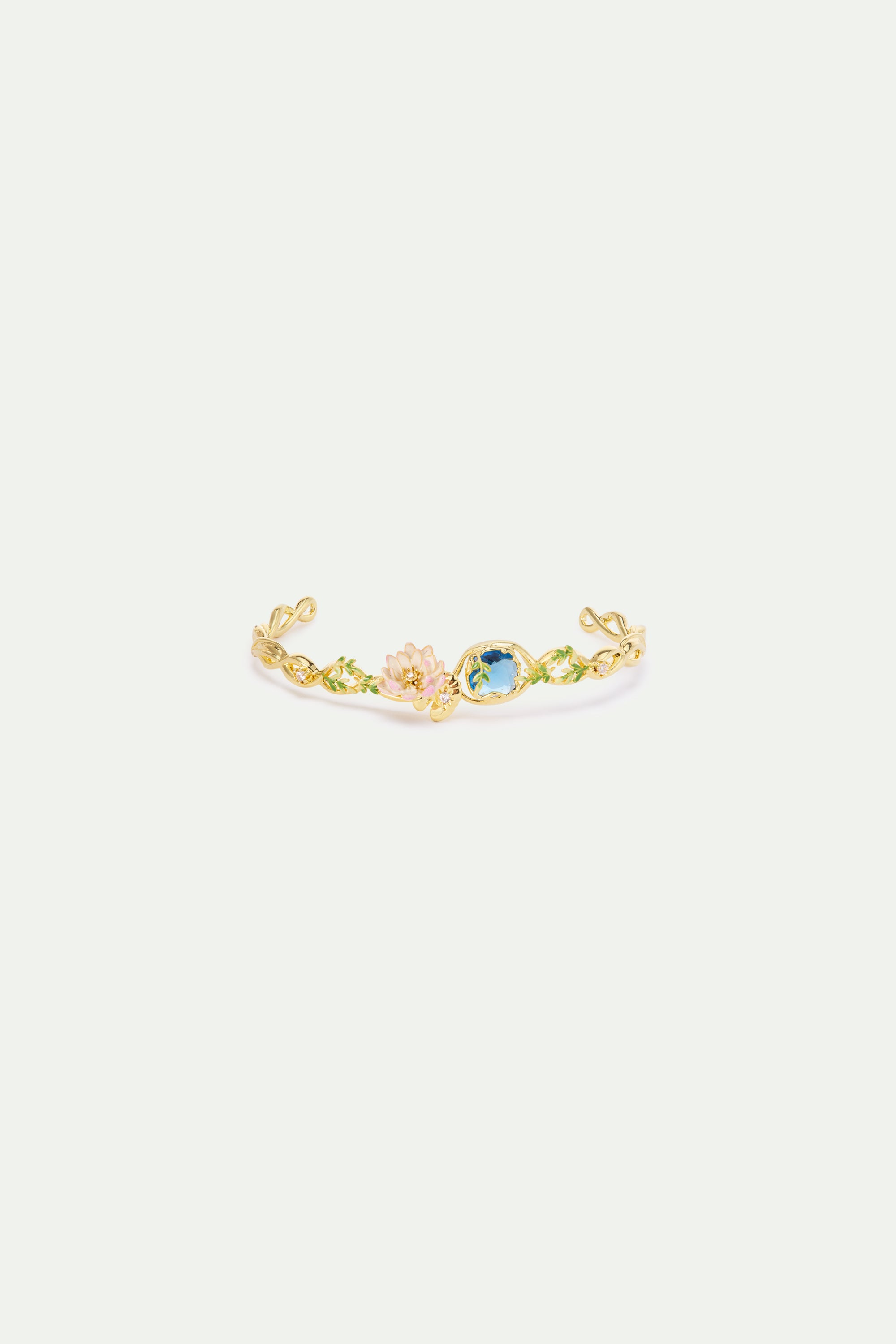 Gold-toned cuff bracelet with green enamel leaves, a pink flower with clear stones, and an oval blue gem.