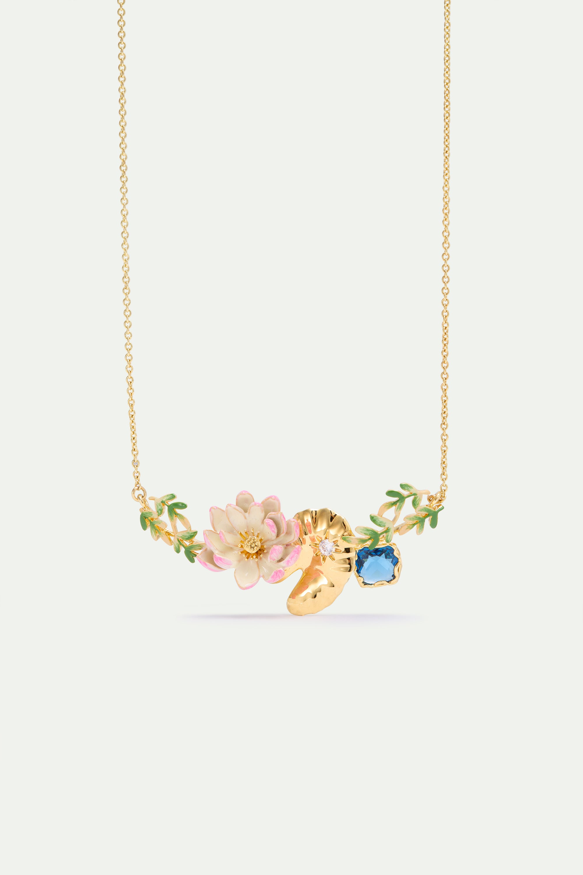 Gold-toned chain necklace with a pink and white water lily, green leaves, a gold-toned lily pad, a blue faceted stone, and a