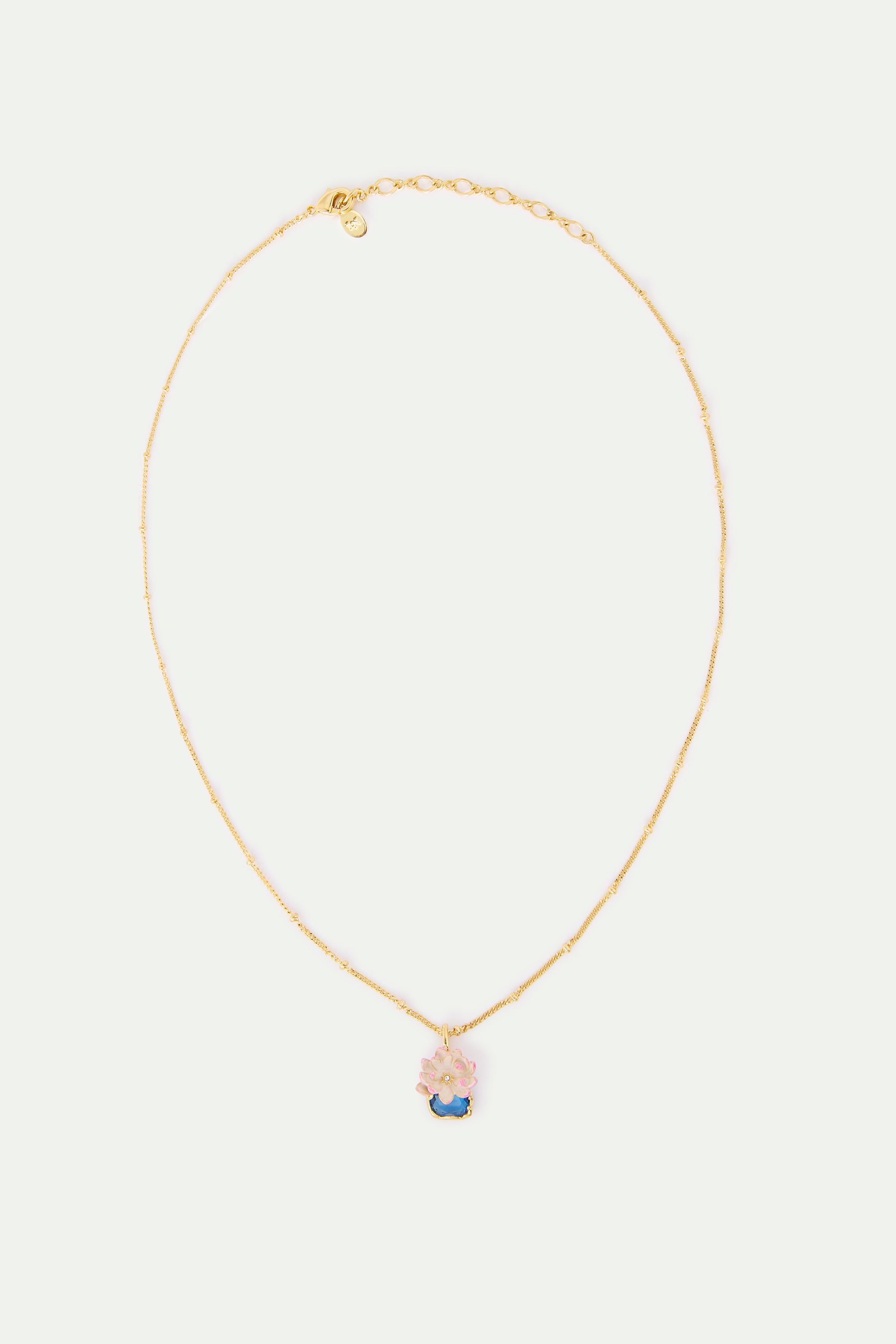 Gold-toned beaded chain necklace with a pink flower pendant on a blue base with a gold-toned outline.