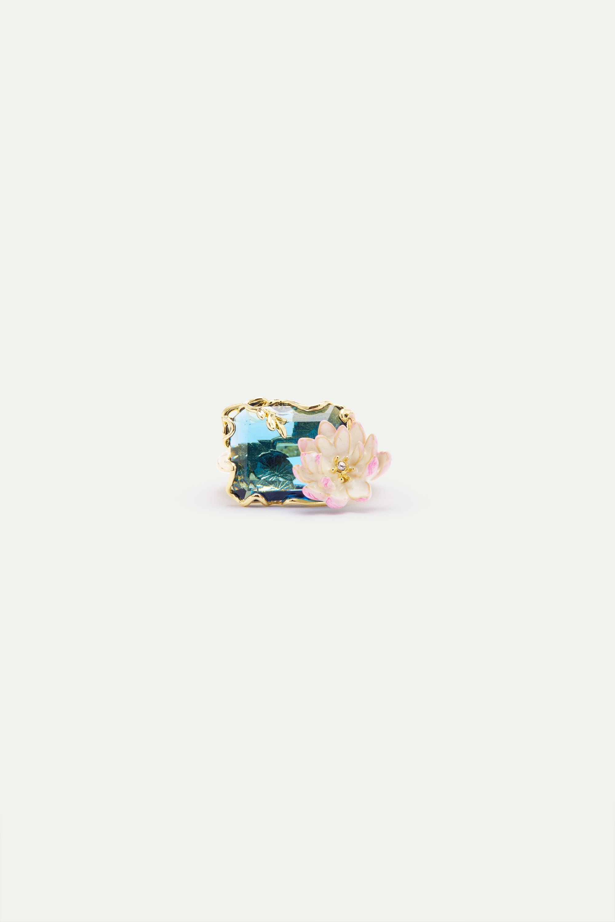 Gold-toned ring with a rectangular blue-green faceted stone depicting a water lily scene, accented by a pink and white lotus