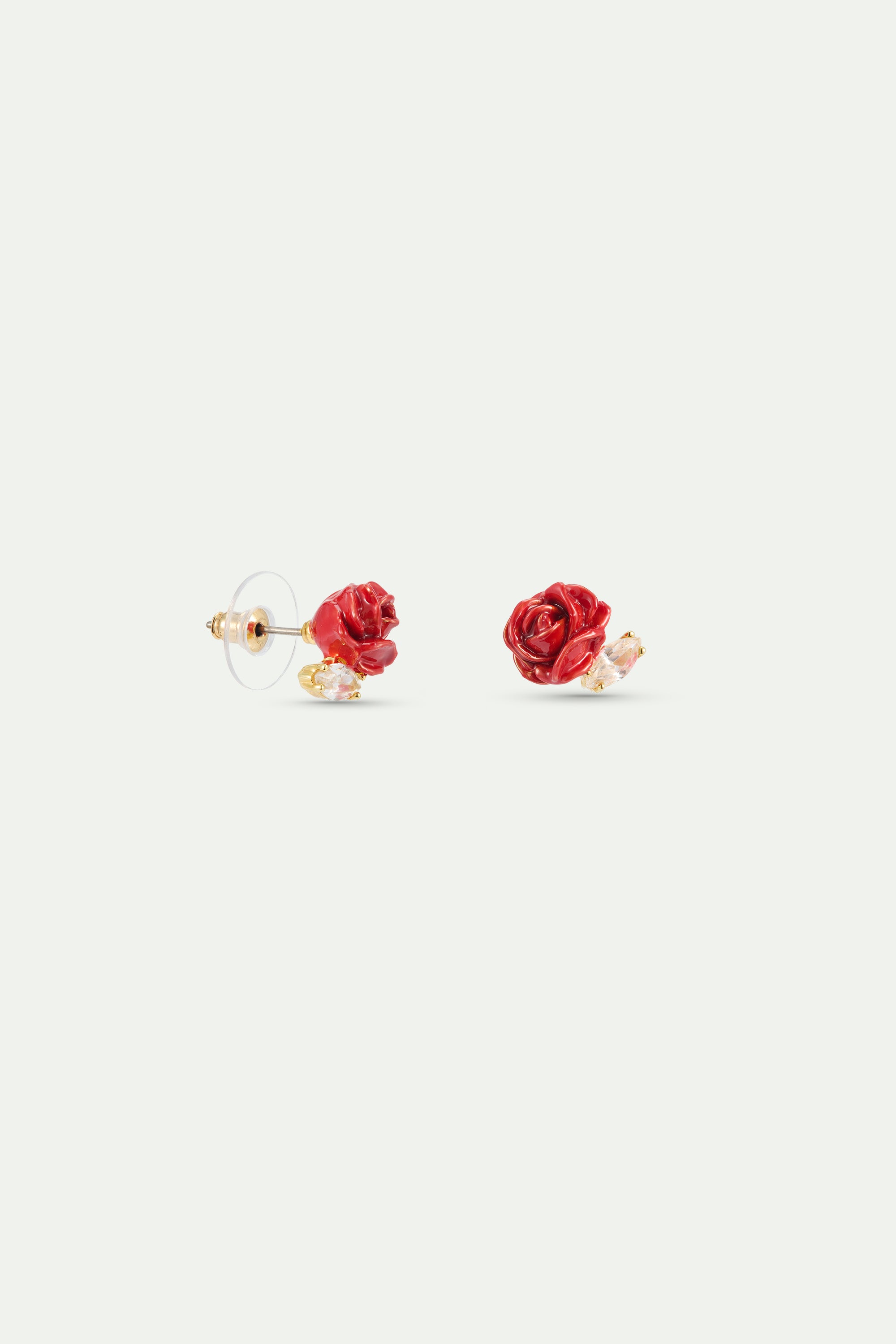 Pair of post earrings, each with a sculpted red rose and a clear faceted stone set in gold-toned metal.