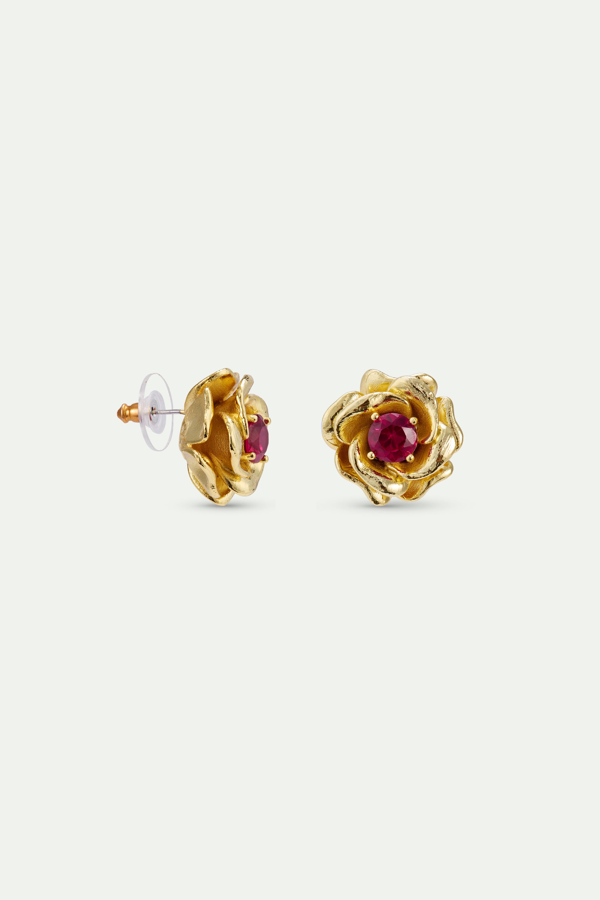 Pair of gold-toned rose stud earrings, each with textured petals and a round, dark red stone at its center.