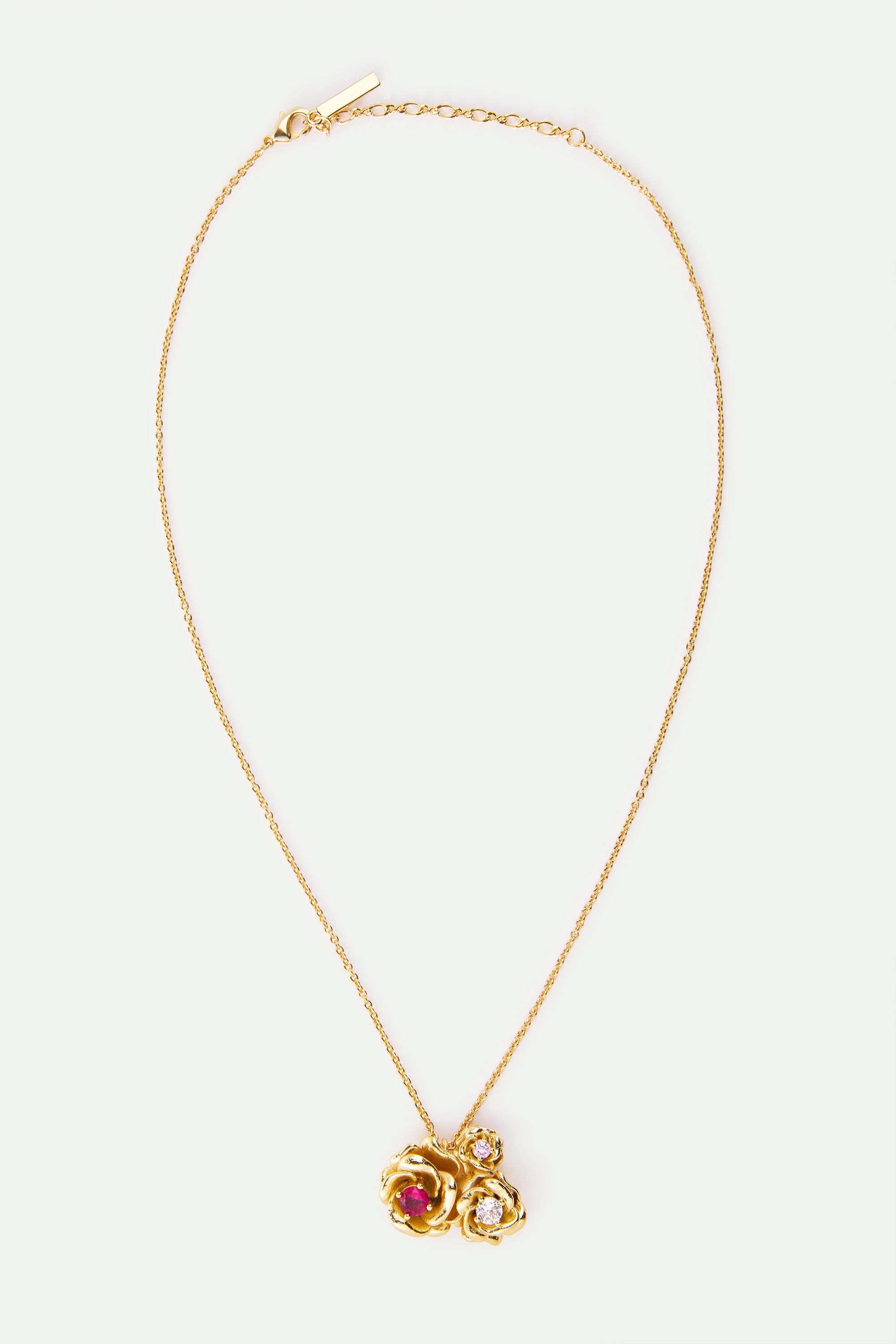 Gold-toned necklace with three rose pendants: one large with a red stone, two smaller with clear stones. Lobster clasp.