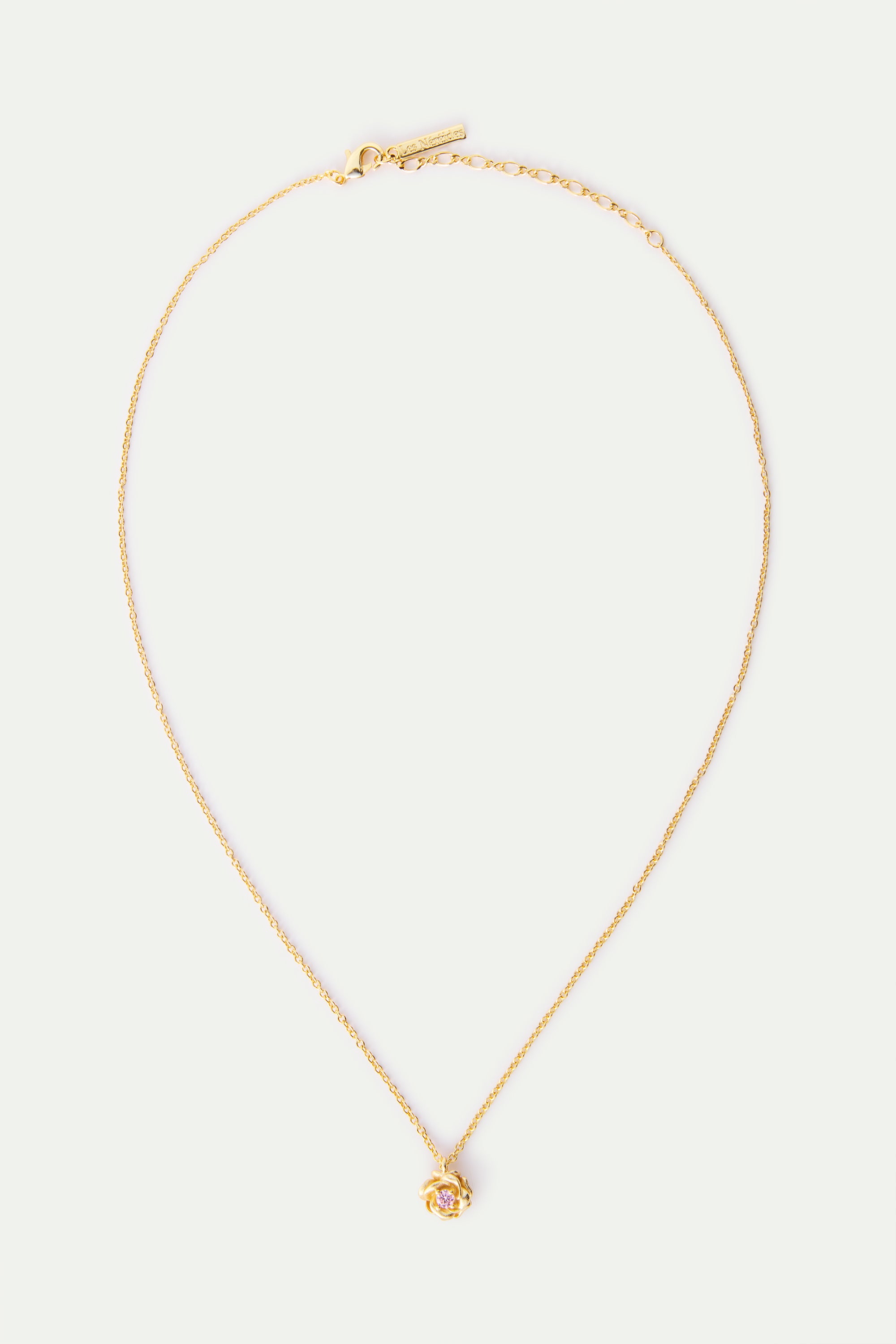 Gold-toned necklace with a delicate chain, a small rose-shaped pendant featuring a pink stone, and a lobster clasp with an ex
