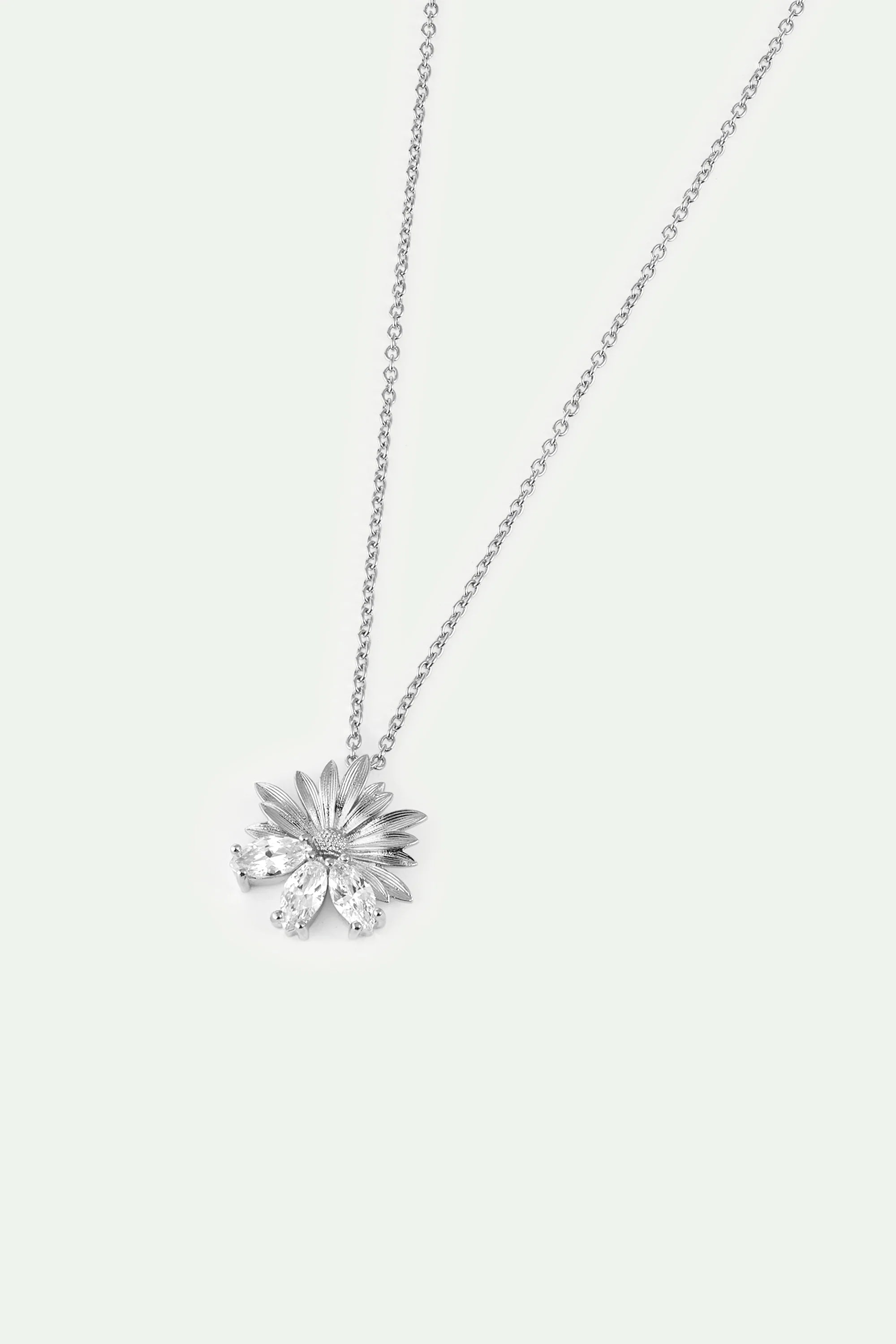 Silver-toned necklace with a flower pendant featuring textured petals and three marquise-cut clear stones at the bottom.