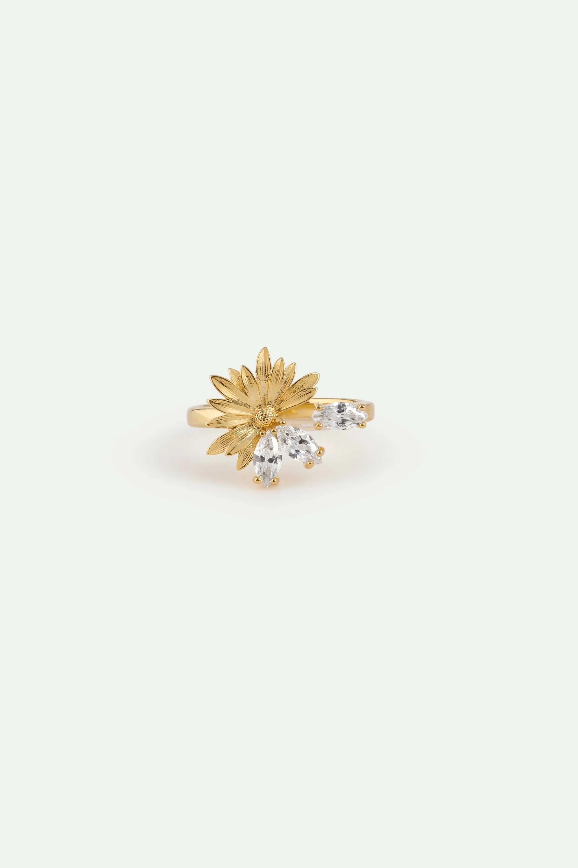 Gold-toned adjustable ring with a textured flower and four clear marquise-cut stones.