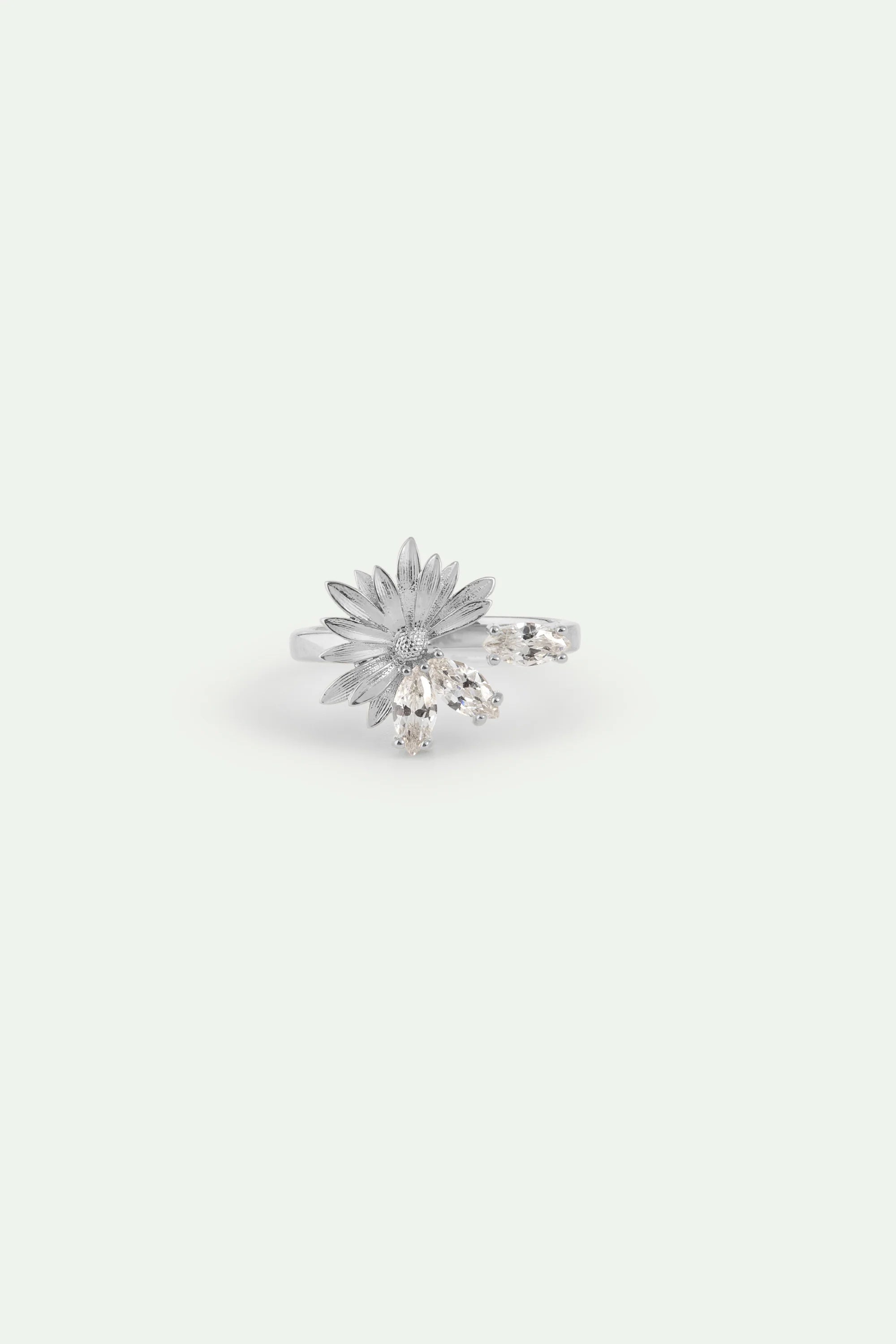 Silver-toned adjustable ring with a textured flower design, a small clear stone at its center, and three clear marquise-cut s