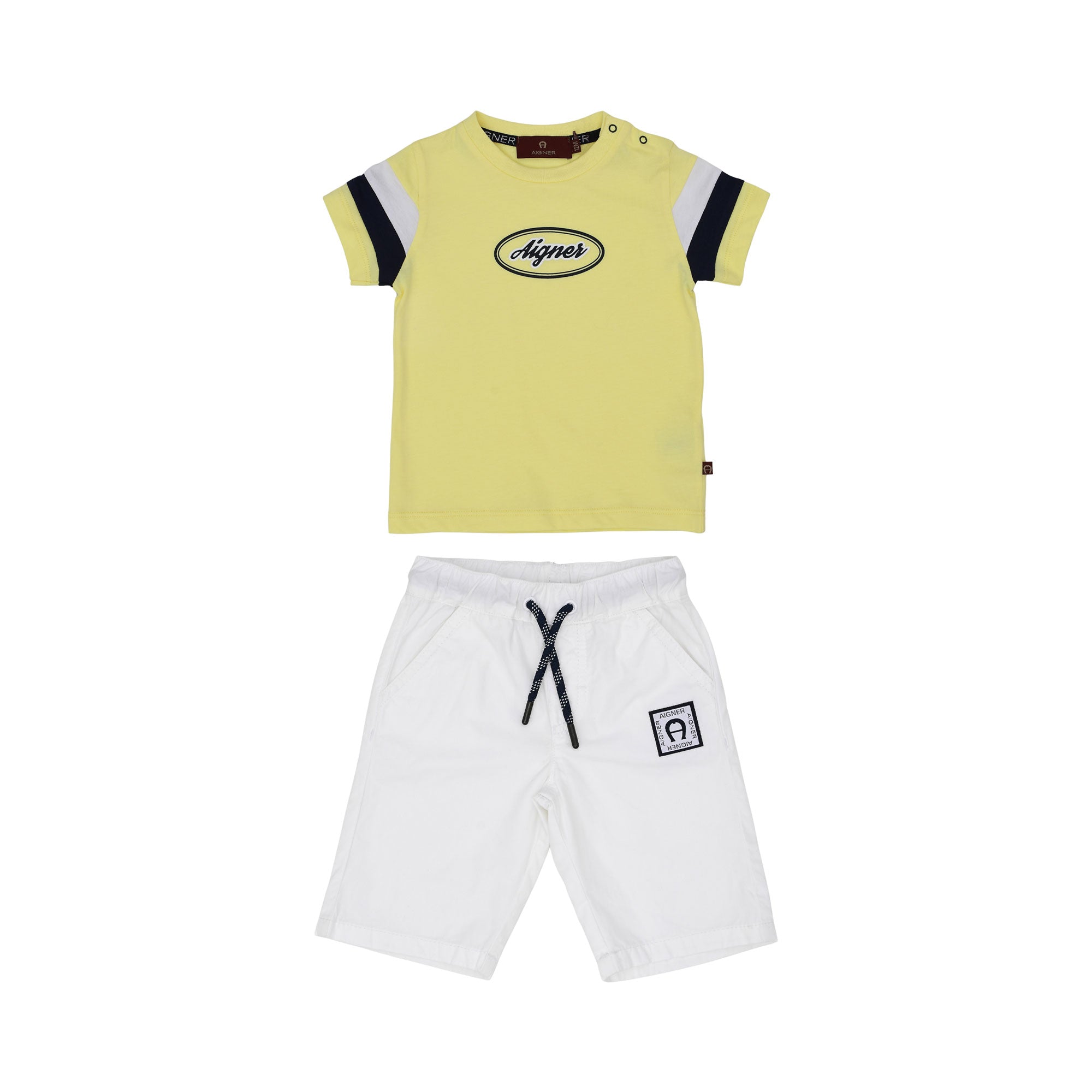 Full front view of the Aigner Kids boys set featuring a yellow T-shirt with an oval logo and white shorts with a navy drawstring.