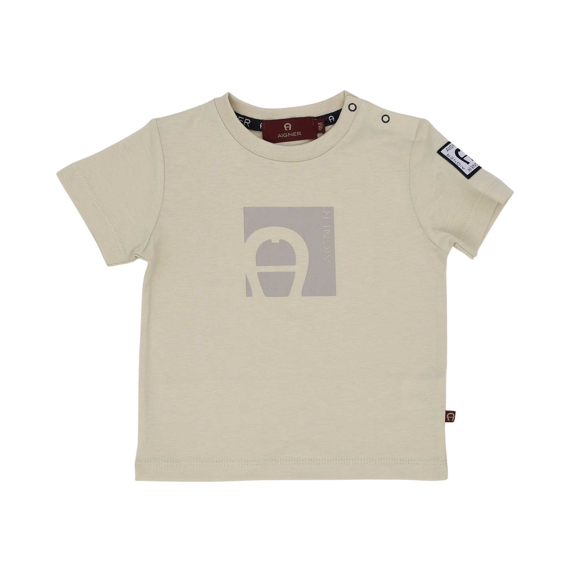 Front view of a beige Aigner Kids baby T-shirt featuring a tonal square horseshoe logo graphic on the chest and popper buttons on the shoulder.