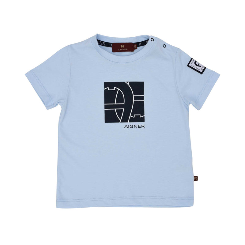 Front of a sky blue Aigner Kids baby T-shirt featuring a large navy square horseshoe logo graphic on the chest and popper buttons on the shoulder.
