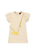 Front view flat-lay studio shot of the Aigner Kids baby girls cream short-sleeve dress, showcasing its dramatic gathered puff sleeves and central golden-yellow crossbody handbag graphic illustration.