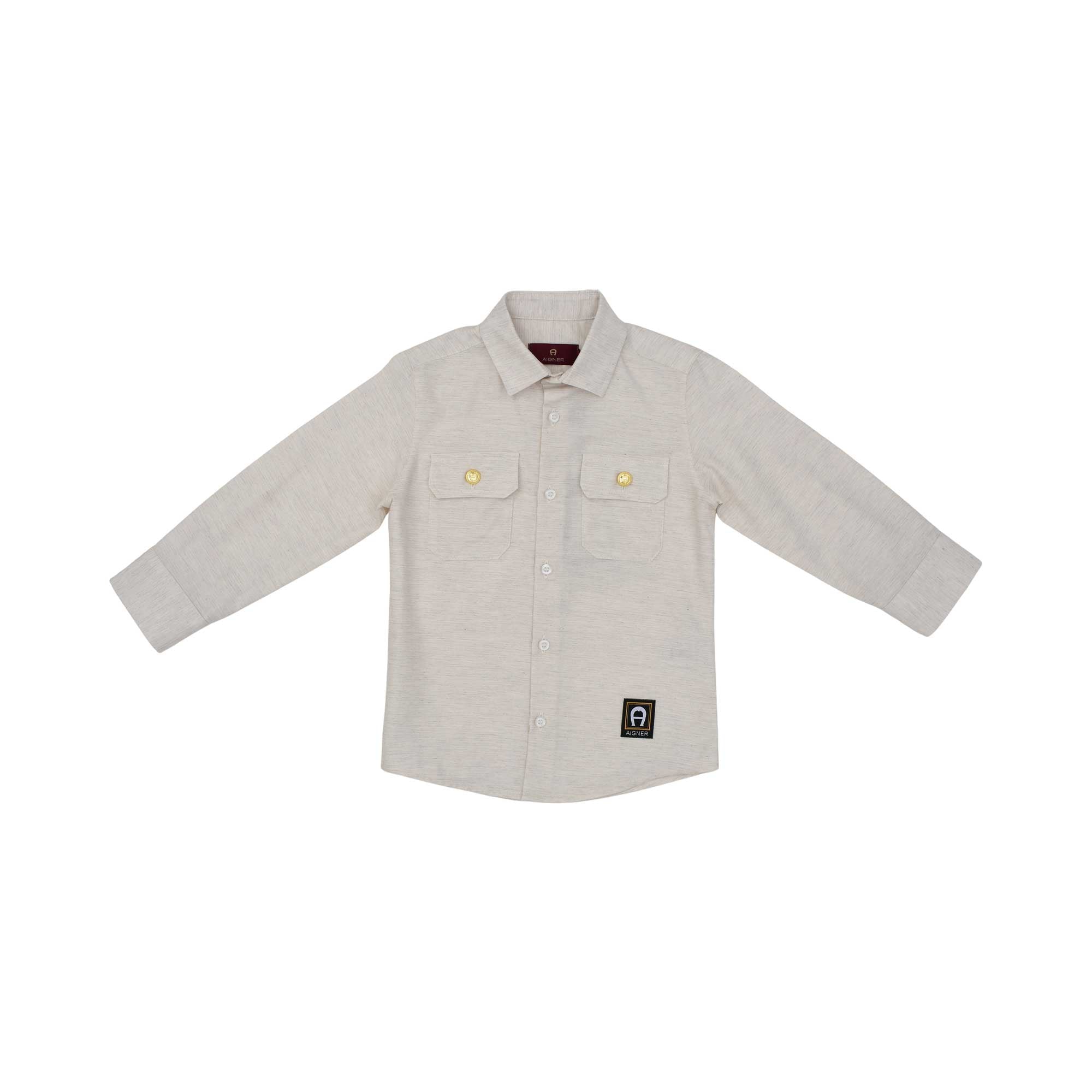 A long-sleeved beige melange button-down shirt for boys by Aigner Kids. It features two chest pockets with gold buttons, a central button placket, and a small navy and gold logo patch on the lower left.