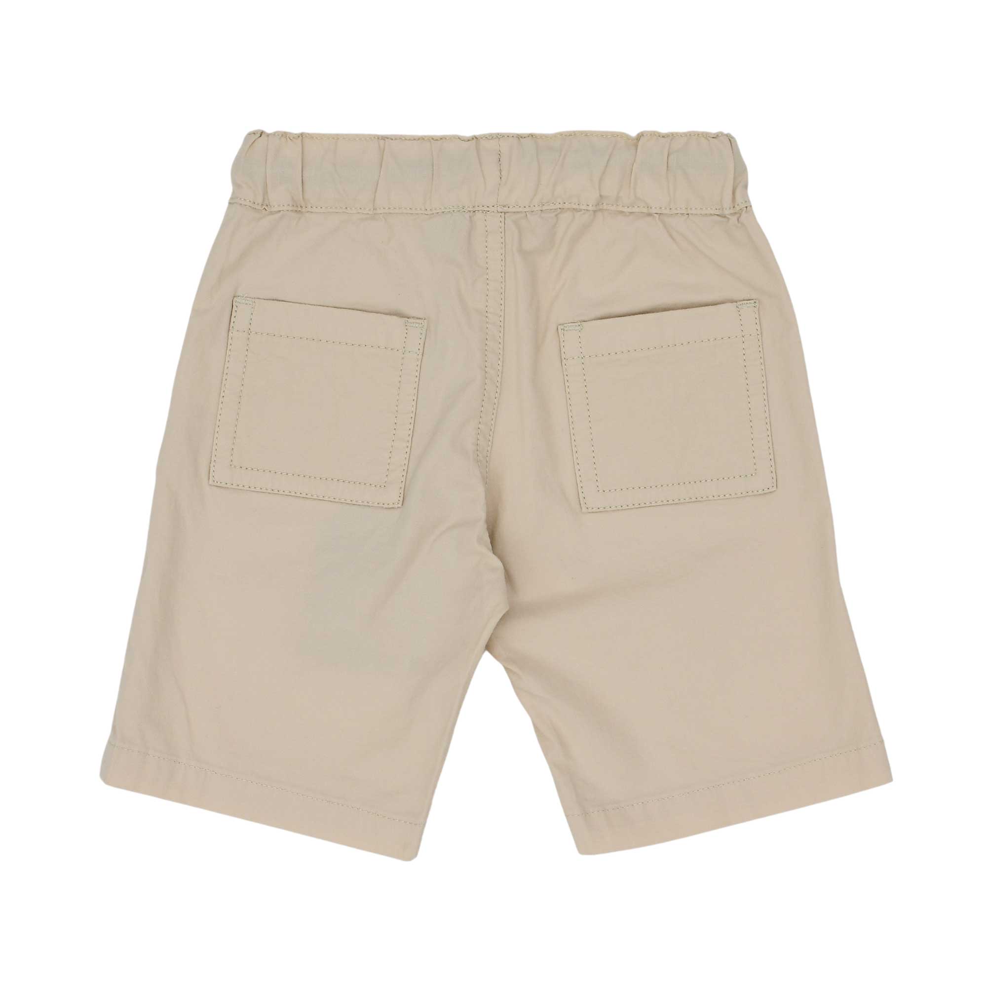 Rear view of the Aigner Kids set showing the plain white back of the shirt and two patch pockets on the beige shorts.