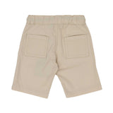 Rear view of the Aigner Kids set showing the plain white back of the shirt and two patch pockets on the beige shorts.