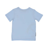 The reverse side of a plain light blue Aigner Kids T-shirt, showing a clean back and the side profile of the graphic print wrapping slightly around the edge.