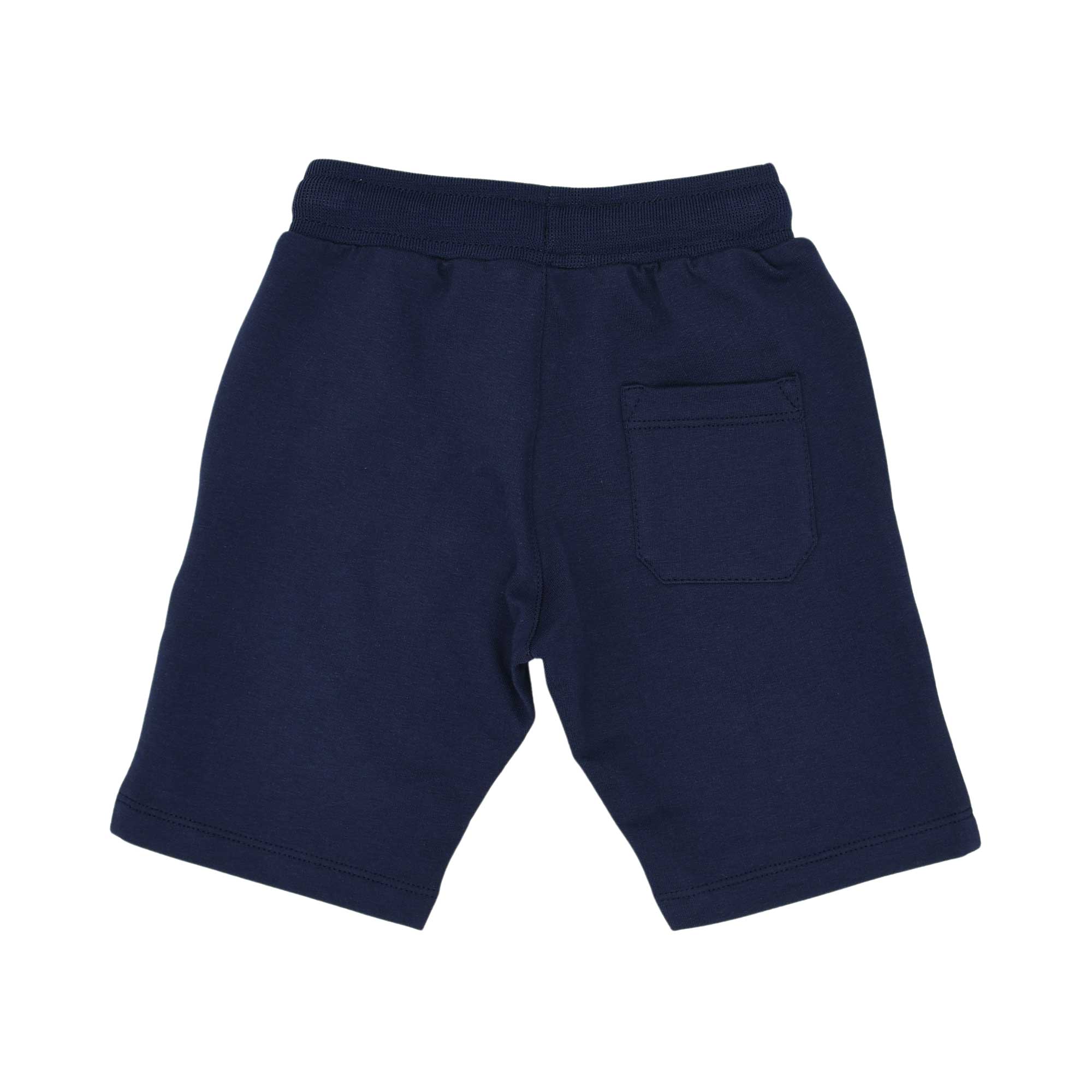 Back view of the navy shorts showing the comfortable elastic waistband and light blue logo print.
