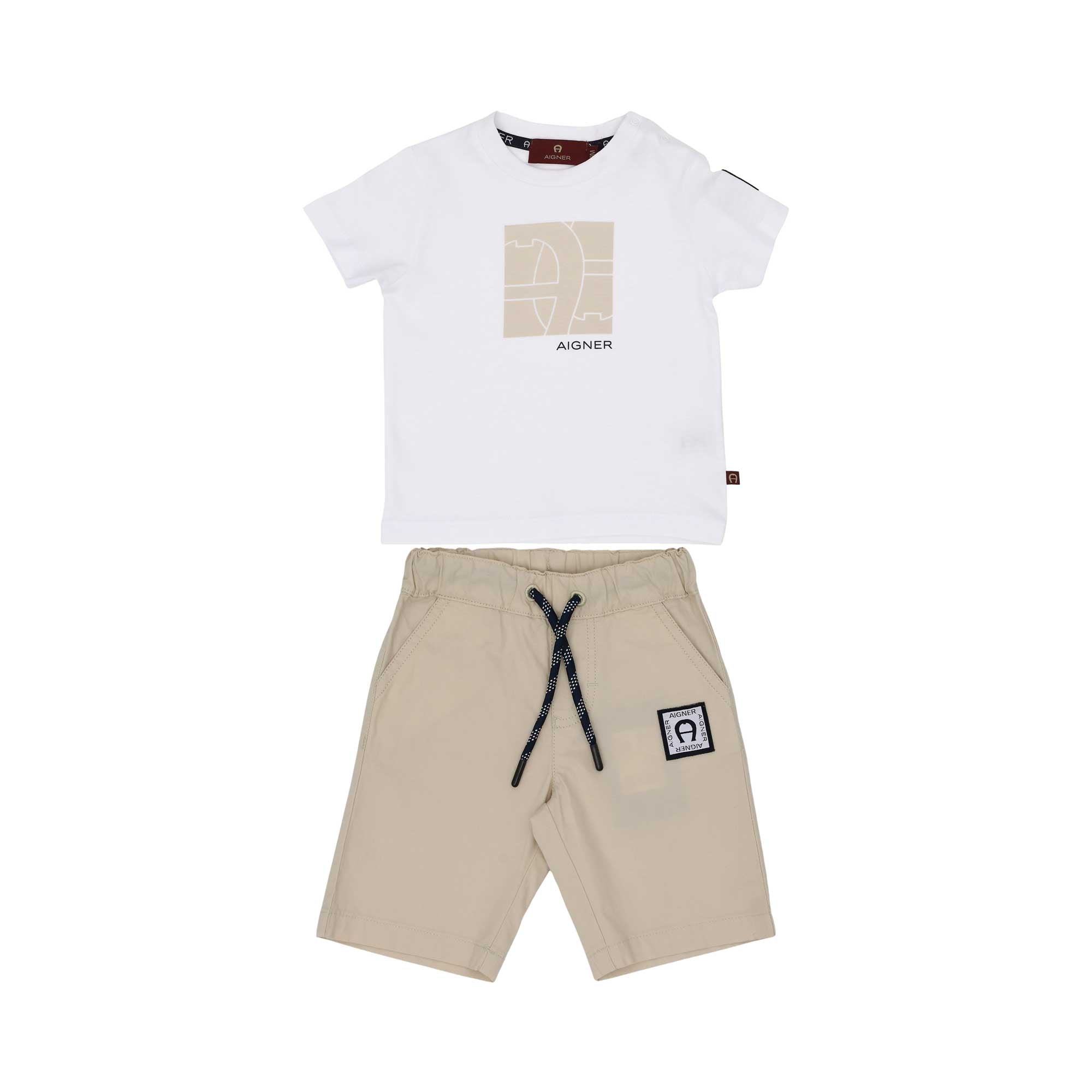 A two-piece Aigner Kids outfit for boys featuring a white t-shirt with a beige logo print and matching beige drawstring shorts.