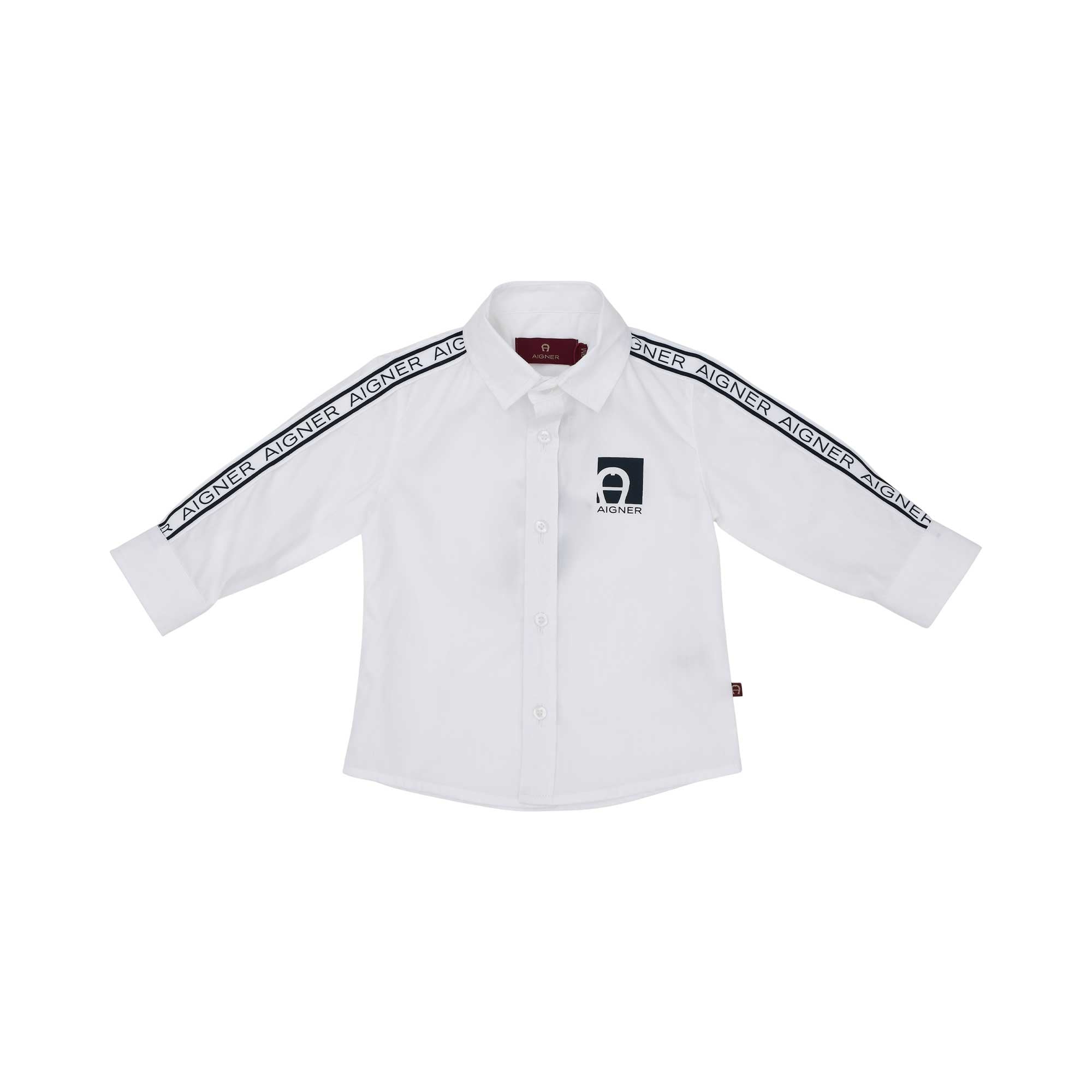 Front view of a white Aigner Kids boys' long-sleeved shirt featuring black logo tape along the shoulders and a black square horseshoe logo on the chest.