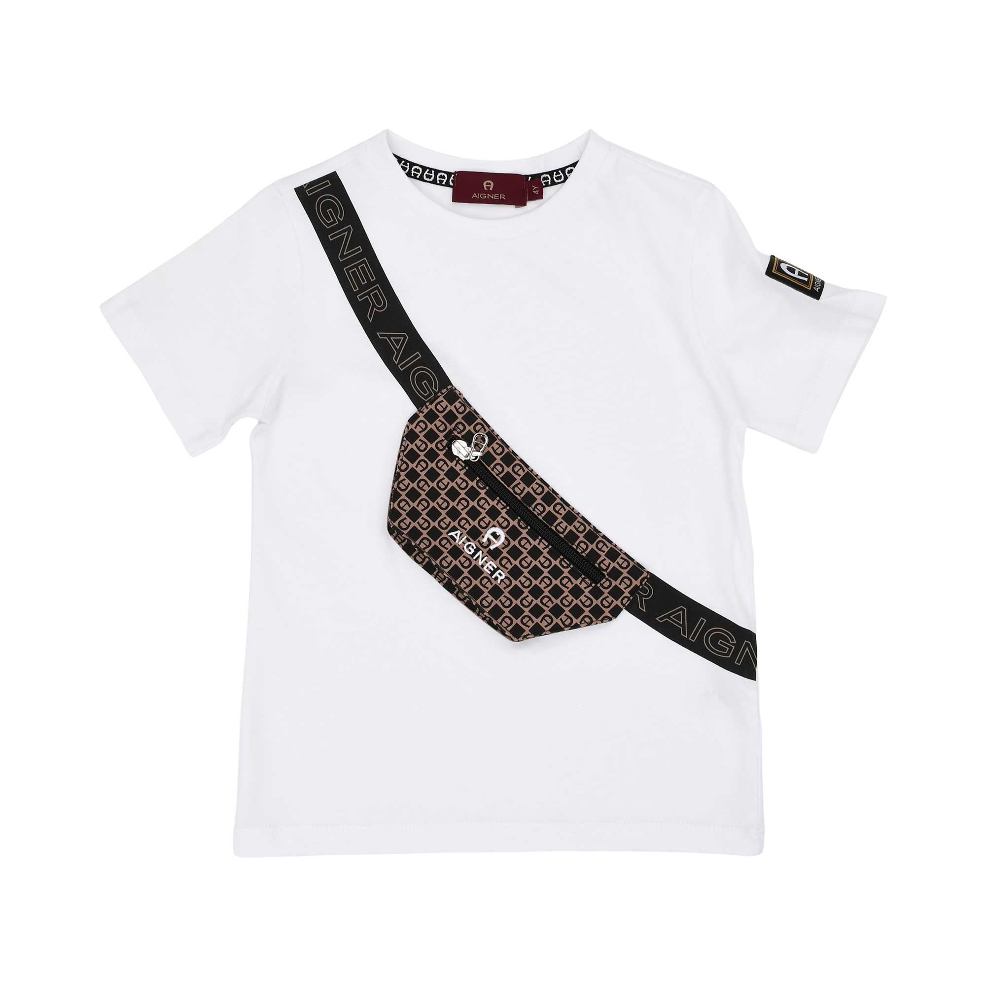 A white boys' T-shirt by Aigner Kids featuring a diagonal black strap print and a 3D-effect black pouch with a zipper, resembling a crossbody bag. A small logo patch is visible on the left sleeve.
