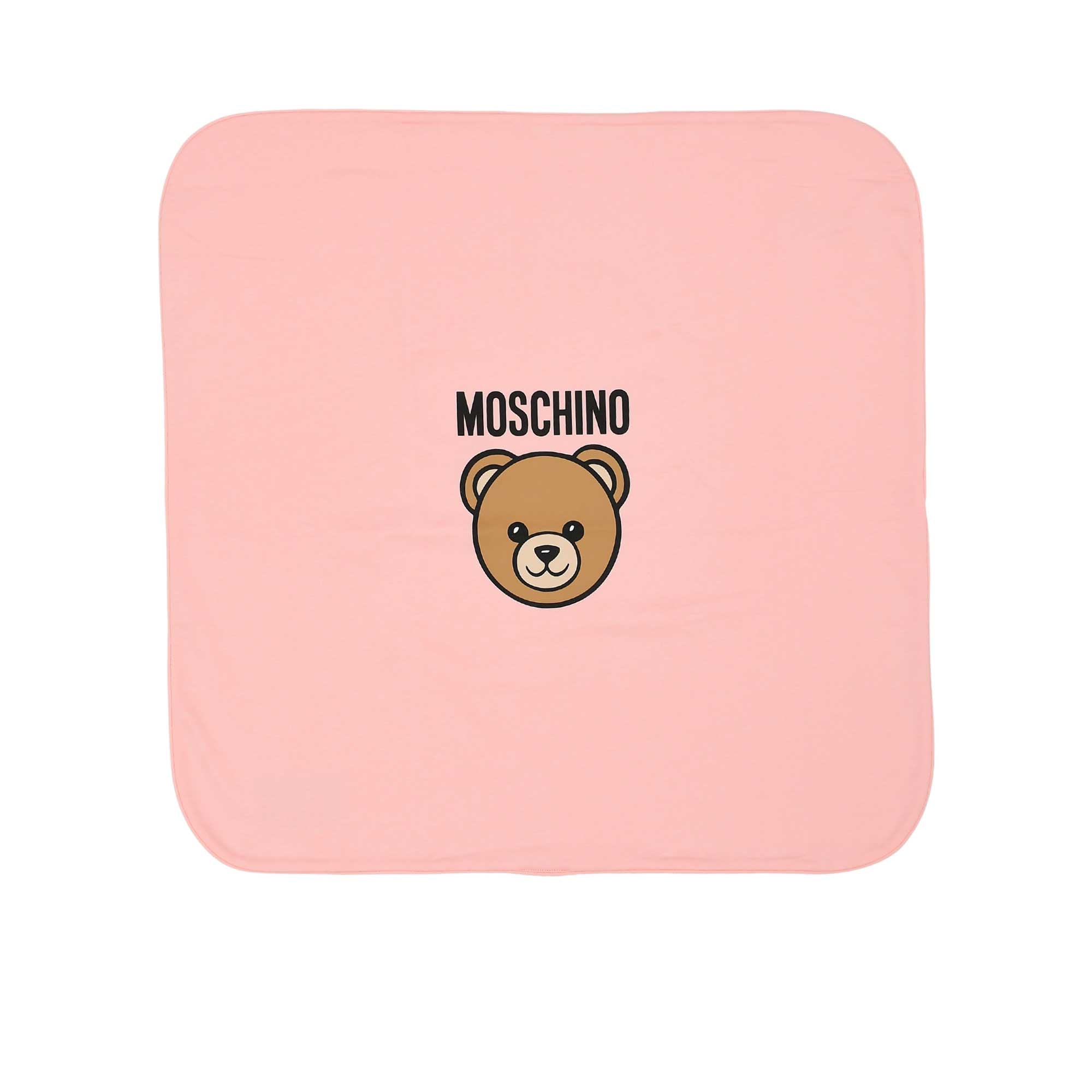 Flat lay view of the square white Moschino baby blanket featuring the central Teddy Bear graphic and brand logo.