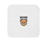 Flat lay view of the square white Moschino baby blanket featuring the central Teddy Bear graphic and brand logo.