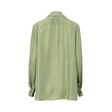 A back -facing studio shot of an Alberta Ferretti long-sleeve blouse in sage green. The blouse features a notched lapel, hidden front buttons, and vertical pleated panels on the bodice and sleeves.
