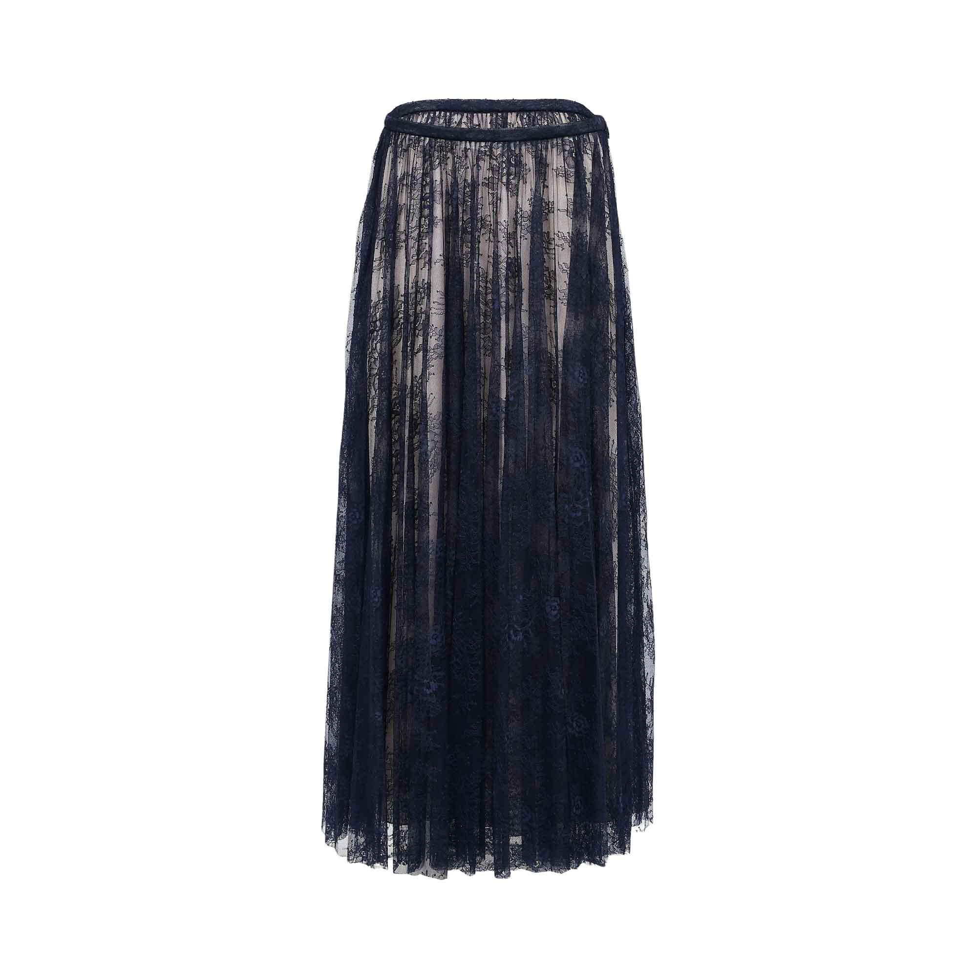 Front view of a navy blue floral lace maxi skirt with a contrasting light lining, showcasing the intricate lace pattern and floor-length drape.