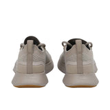 Rear view of the heels of the Allbirds Tree Dasher 2 sneakers, highlighting the flared grey midsole and heel tabs with the embossed logo.