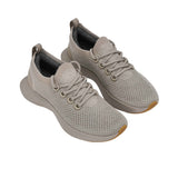 Full view of the natural rubber outsole, featuring a light grey traction tread pattern separated by a matching central foam groove.