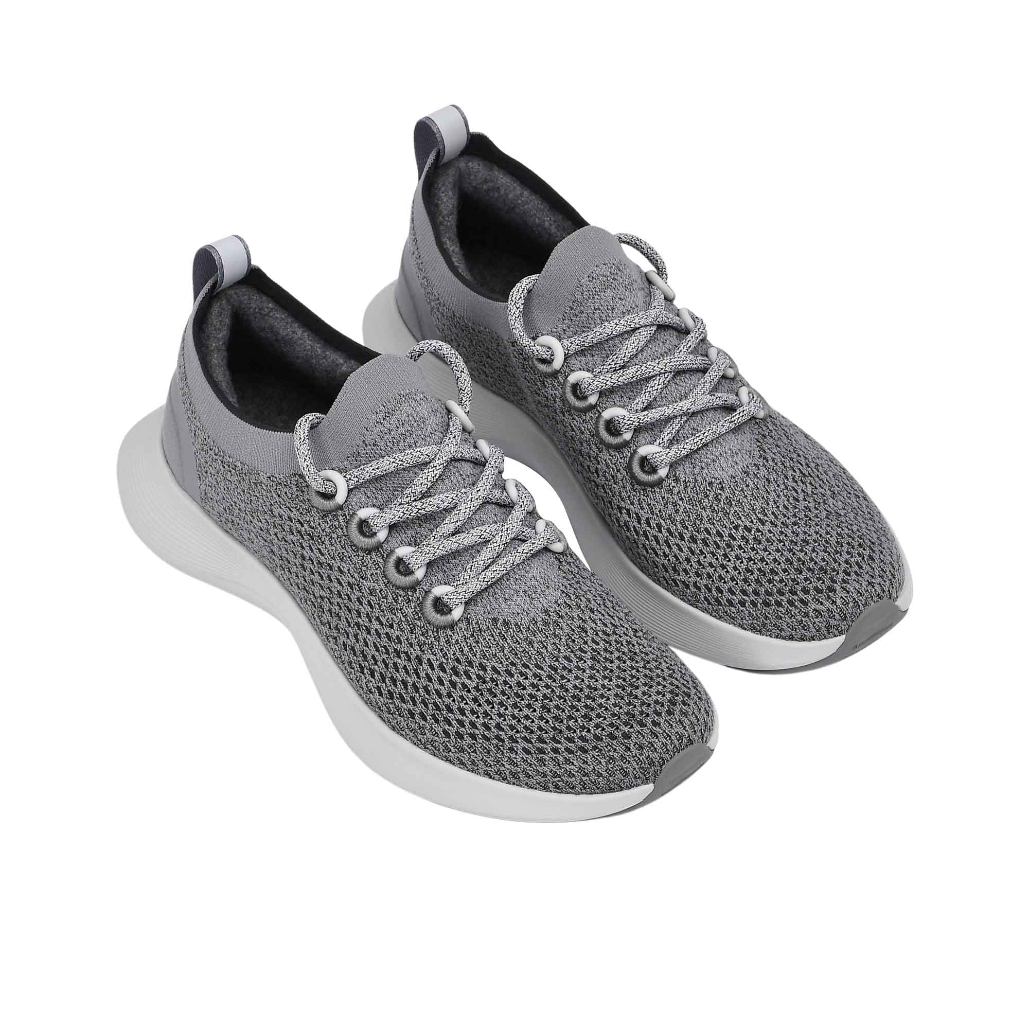 Full view of the natural rubber outsole, featuring a light grey traction tread pattern separated by a white central foam groove.