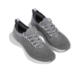 Full view of the natural rubber outsole, featuring a light grey traction tread pattern separated by a white central foam groove.