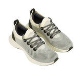 Full view of the natural rubber outsole, featuring a dark black traction tread pattern separated by a dark grey central foam groove.