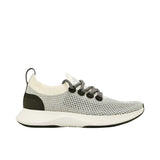 Profile view of a single Allbirds Tree Dasher 2 sneaker, showcasing its monochromatic natural black knit upper, matching black laces, and dark grey midsole.