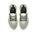 Top-down overhead view of the sneakers, displaying the dark charcoal grey insoles printed with the white Allbirds logo.