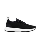 Profile view of a single black Allbirds Tree Runner sneaker with a textured knit upper, black laces, and a thick, contoured white midsole on a plain white background.