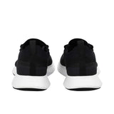 Rear view of a pair of black Allbirds Tree Runner sneakers, showing the fabric heel pull tabs and the subtle embossed "allbirds" branding along the white textured heels.