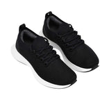 Top-down view of the single white rubber outsole of an Allbirds shoe, displaying a textured black tread pattern on the heel and forefoot sections for traction.