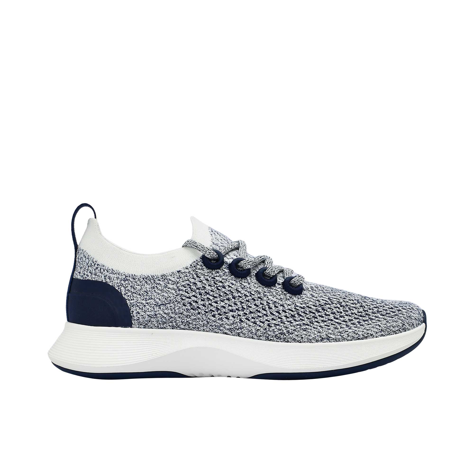 Profile view of a single Allbirds Tree Dasher 2 sneaker, showcasing its marled navy and white knit upper, dark navy blue eyelets, and chunky white midsole.