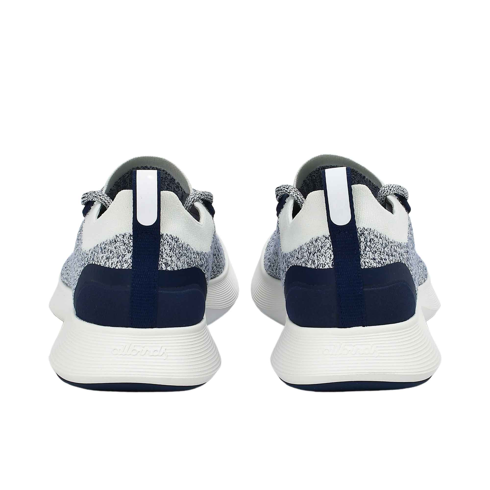 Rear view of a pair of Allbirds Tree Dasher 2 running shoes, showing the textured toe boxes and mixed navy-white patterned laces.